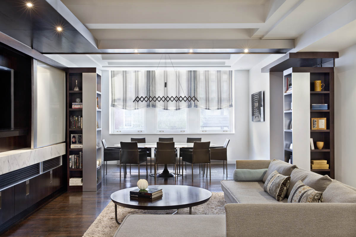 The living area through to the dining Area. Upholstery, floor coverings and window treatments provide connection across the open plan space.