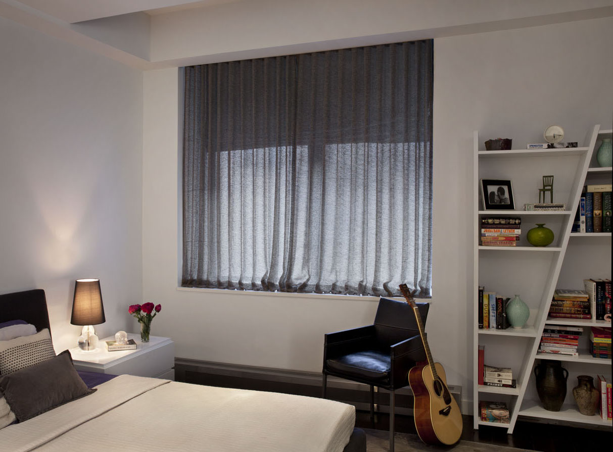 Custom, double layered window treatments soften the master bedroom and new, clean-lined storage and lighting.