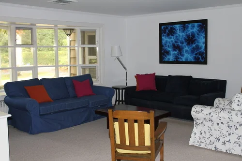 A hodge-podge of furniture squished into a corner of the much larger living room
