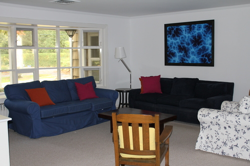 A hodge-podge of furniture squished into a corner of the much larger living room