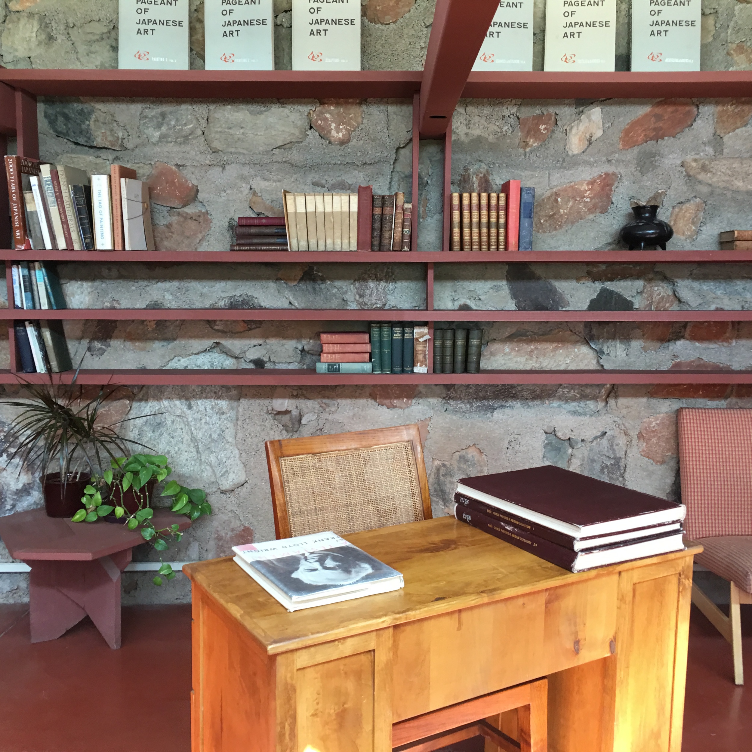 The open shelves in Wright's personal space connect directly to the architecture and material palette of the walls (built from stone gathered on and around the property).