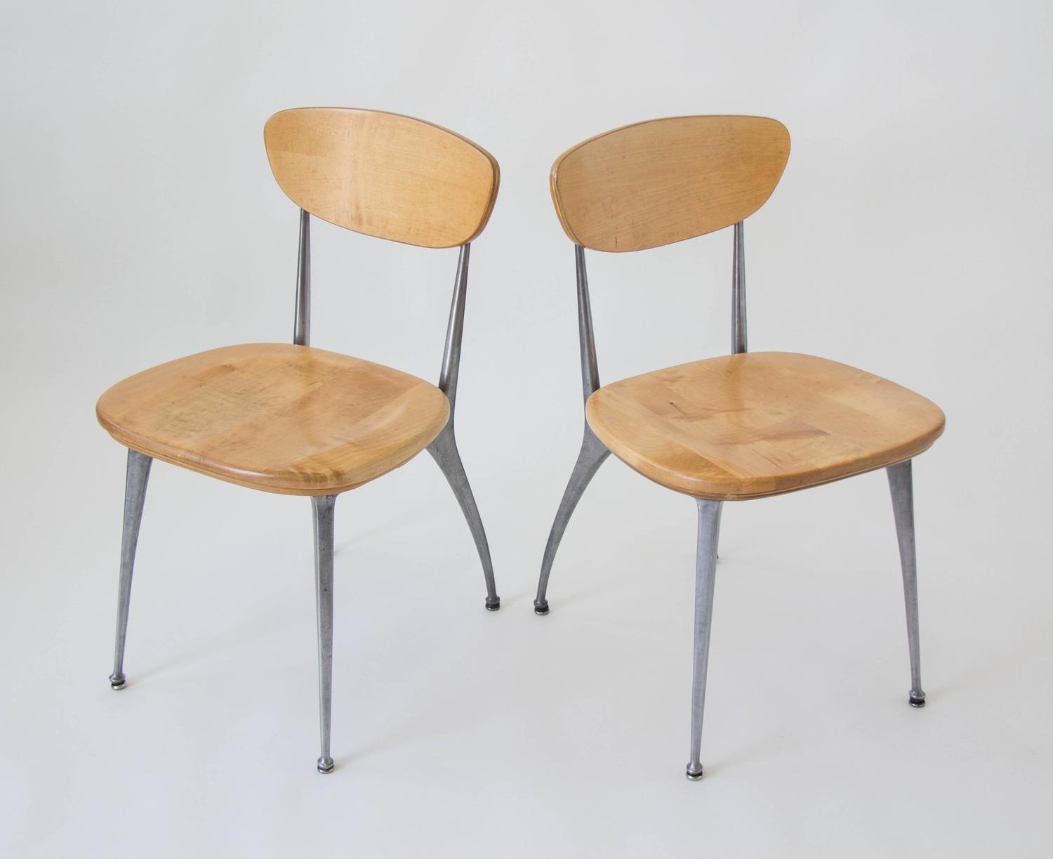 Simple and mass manufactured gazelle leg chairs , American made by Shelby Williams in the 1950s. The simple curve of the aluminum leg is a nice compliment to the plainspoken, school house style birch chairs.