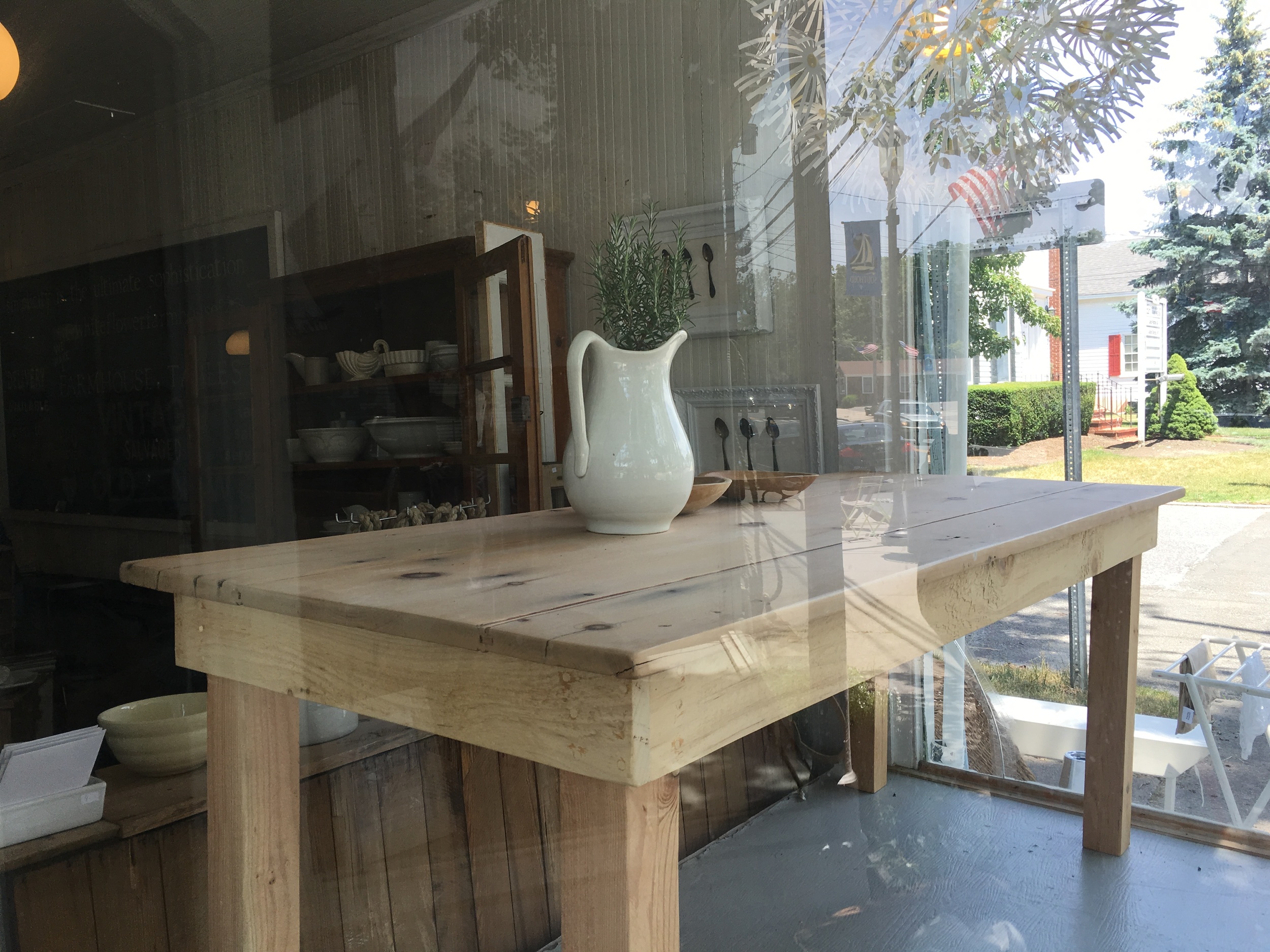 A white jug, fresh herbs and a Main Street view