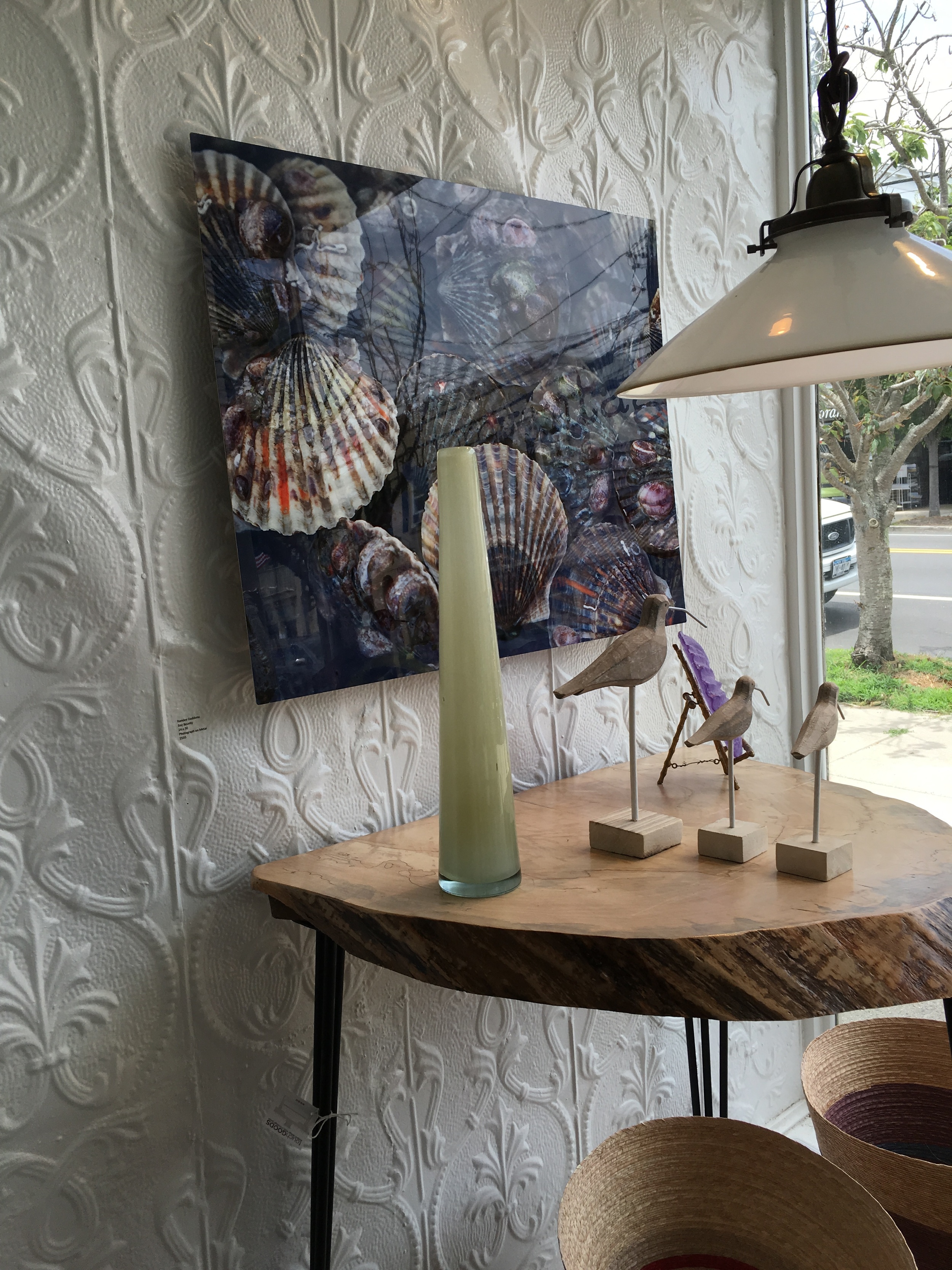 Accessories are all about balance - rustic statues, smooth glass, and glossy photography