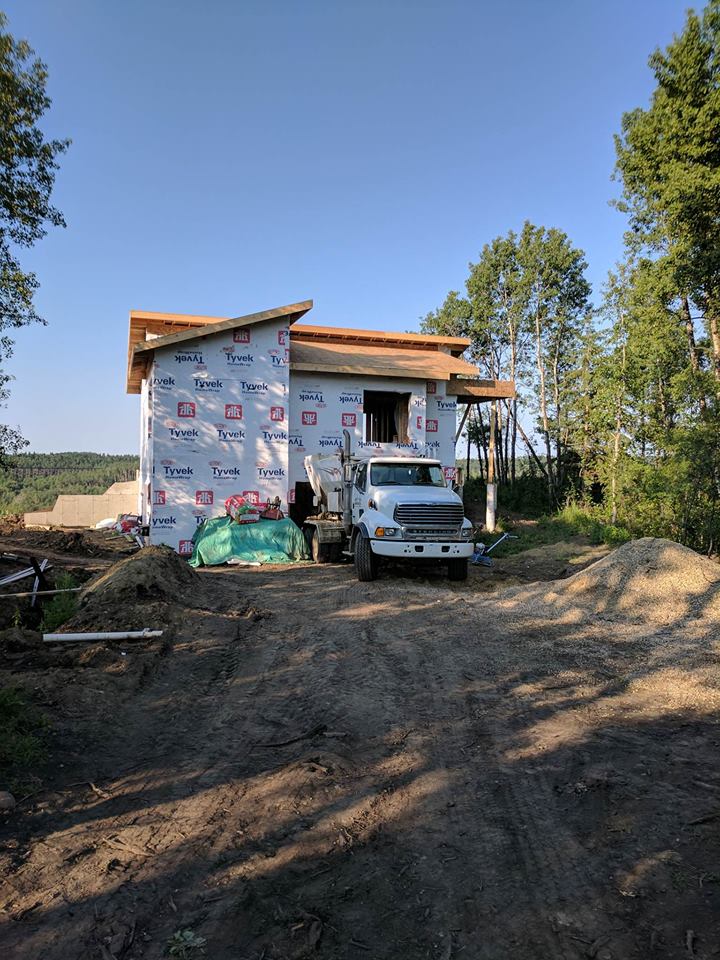 A messy work site! Concrete poured for the basement through the basement living room window. 