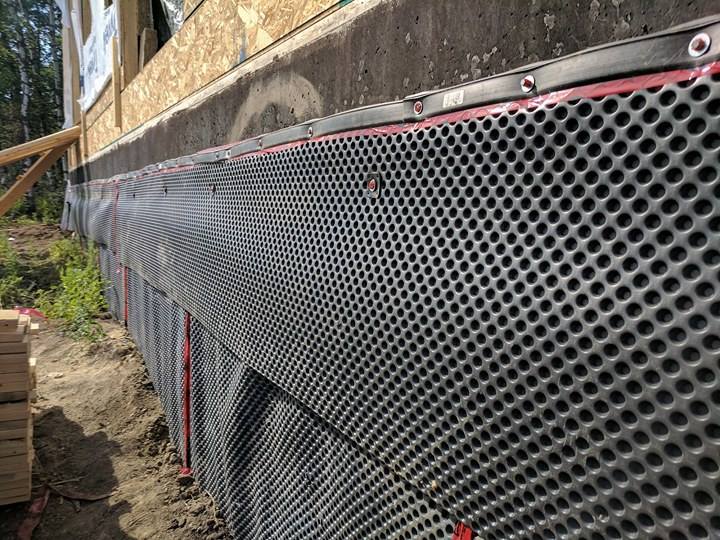 Drainage wrap along the exterior of the foundation wall to help shed water. 