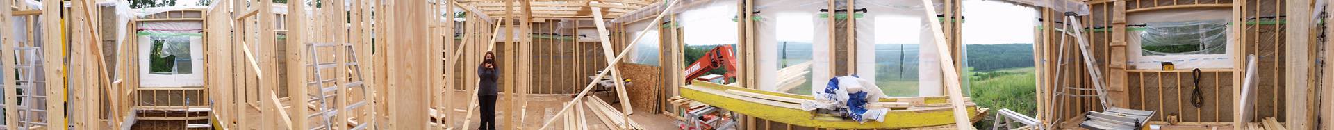 Panorama of the interior before the roof went up. You can see the interior walls have been stood up with the air/vapour barrier installed and 2 layers of Roxul on the exterior side. 
