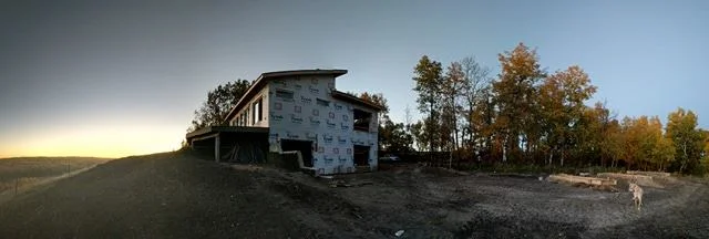 East side of the house overlooking the future off-grid solar system forms being prepared for concrete (right side).