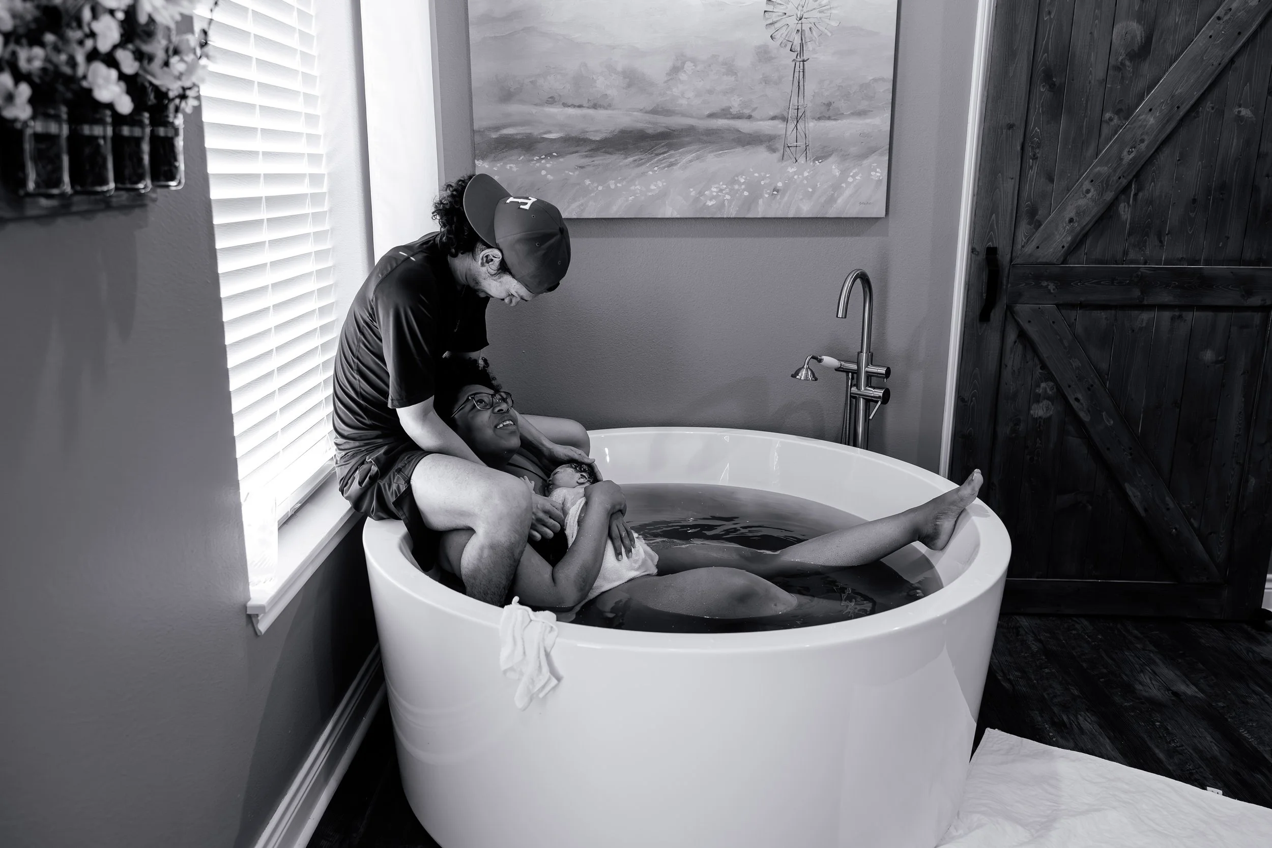 A wife and husband celebrating their new baby after the mom labored and delivered in a birth tub at the Heritage Birth Center.