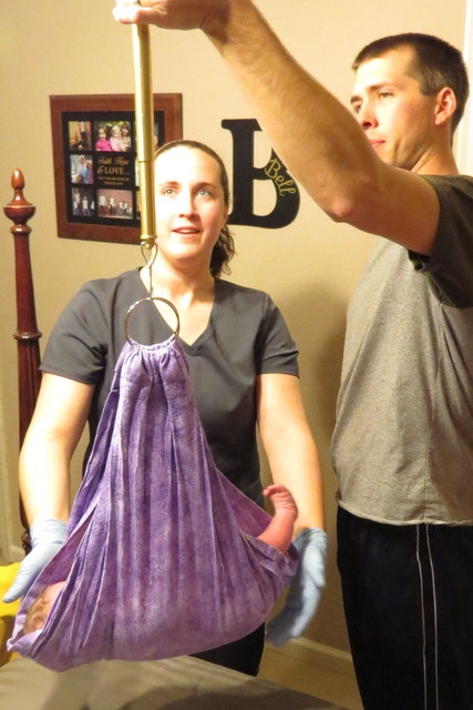 Dad weighing his baby girl