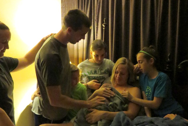 Dad leading everyone in prayer, thanking God for Emalynn's safe birth