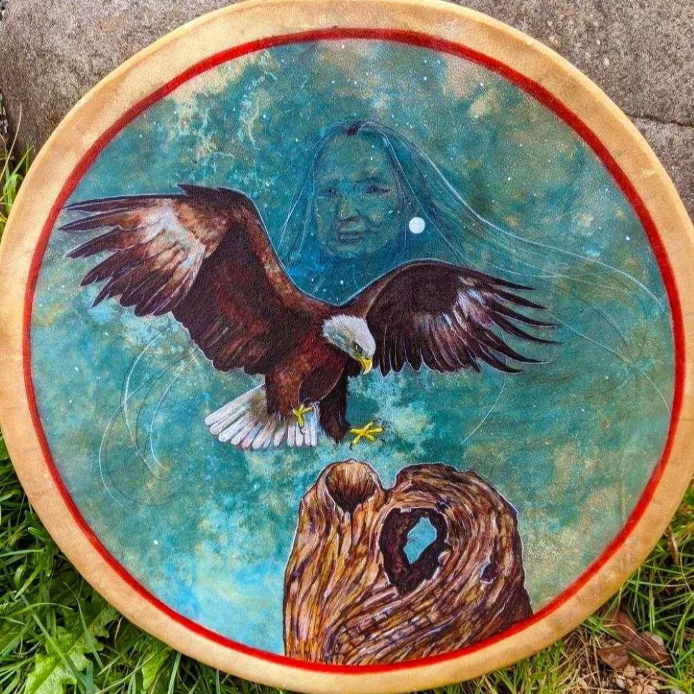 Eagle medicine drum by David Craig, a bald eagle in flight before an elder's face