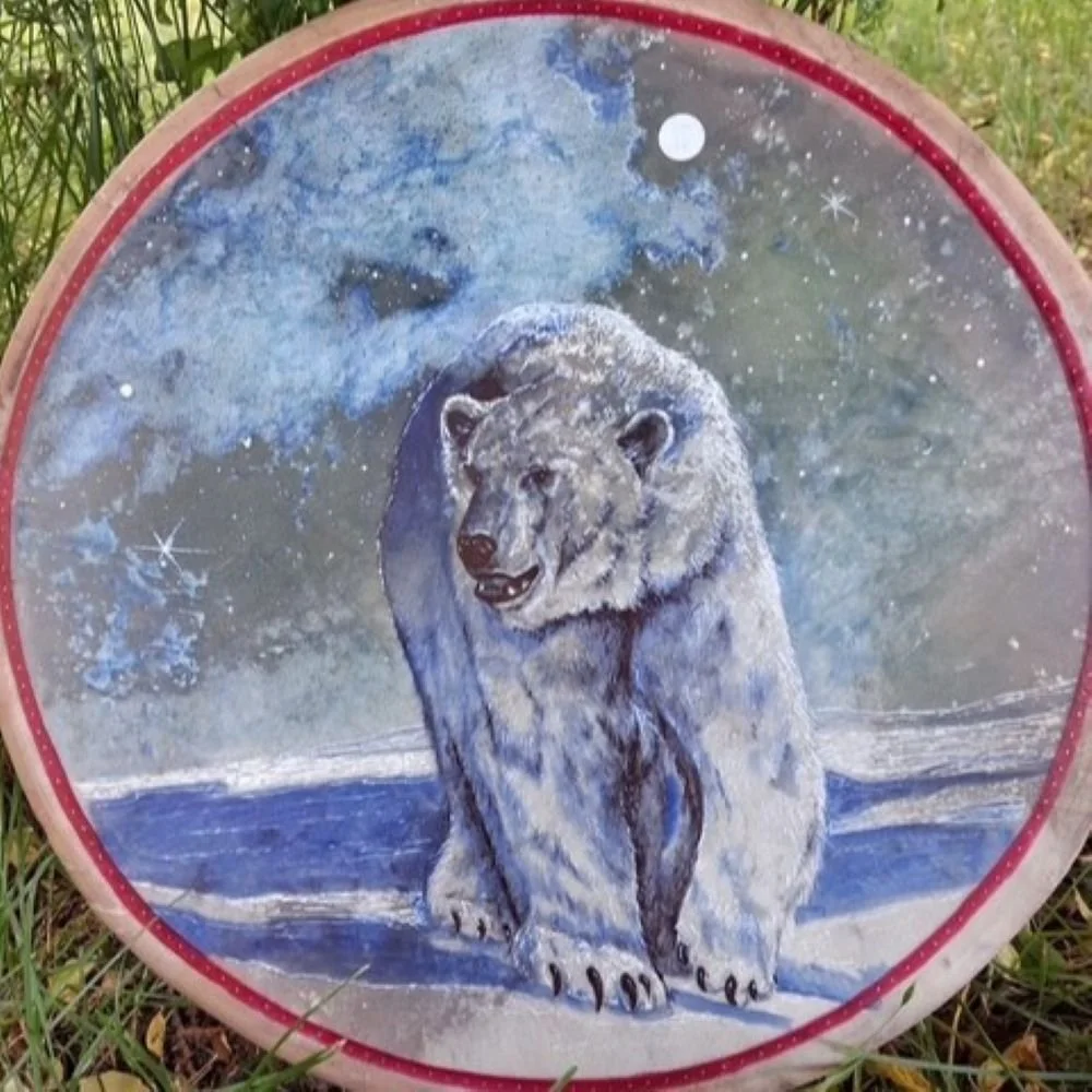 Polar bear medicine drum by David Craig, a polar bear on the ice beneath a starry moonlit sky