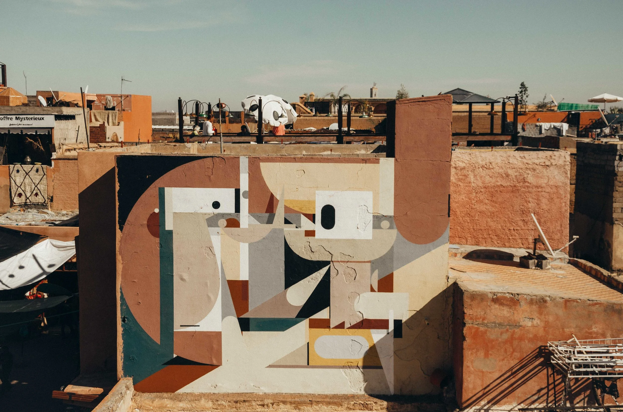 An unexpected piece of street art atop a rugged building in Marrakech. I like how the colours of the mural blend seamlessly with the environment!