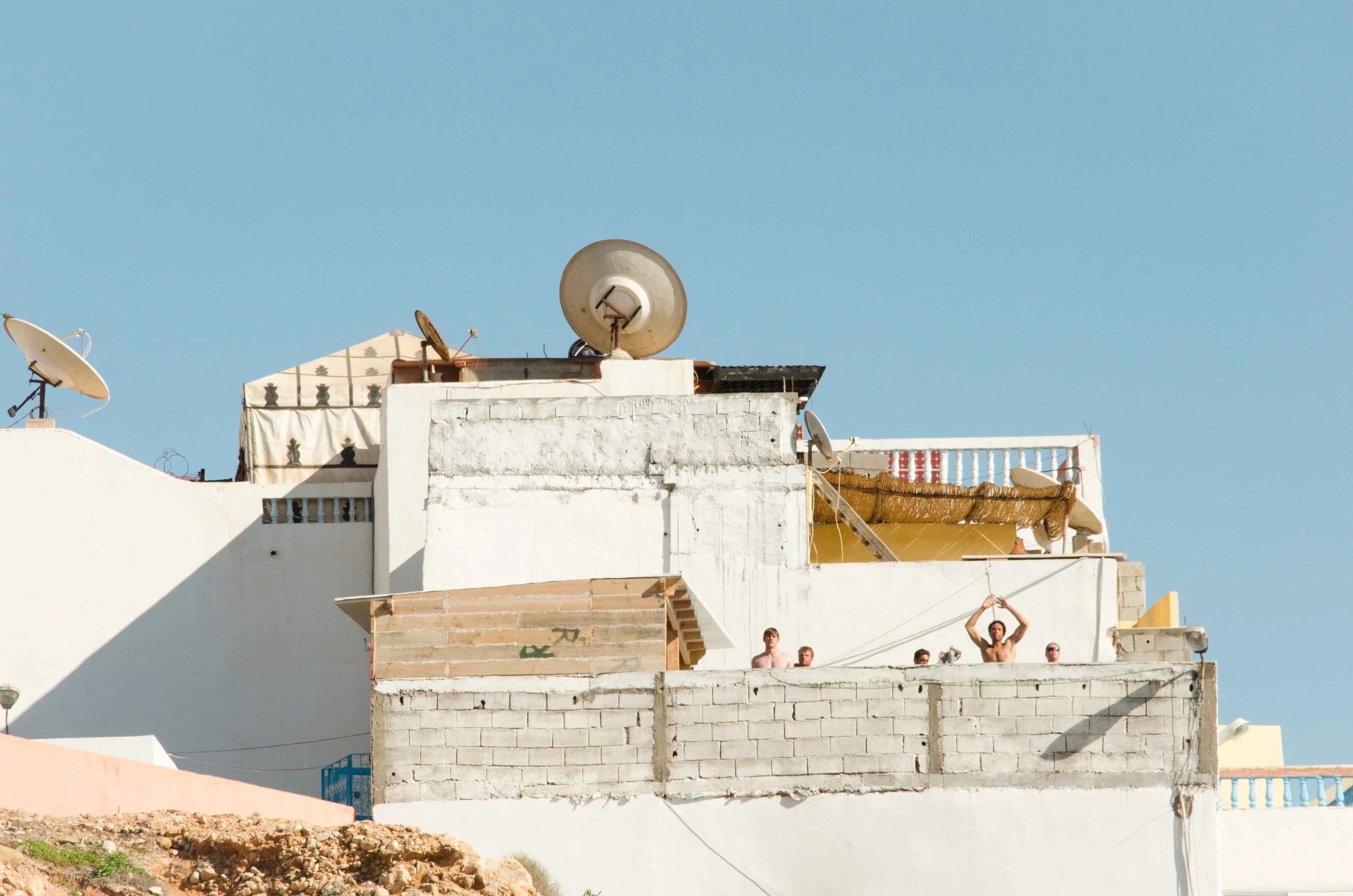 Shot in Morocco; I was having a stroll at the beach and the architecture caught my attention; upon a closer look, I noticed that there were a bunch of people exercising vigorously on the rooftop!