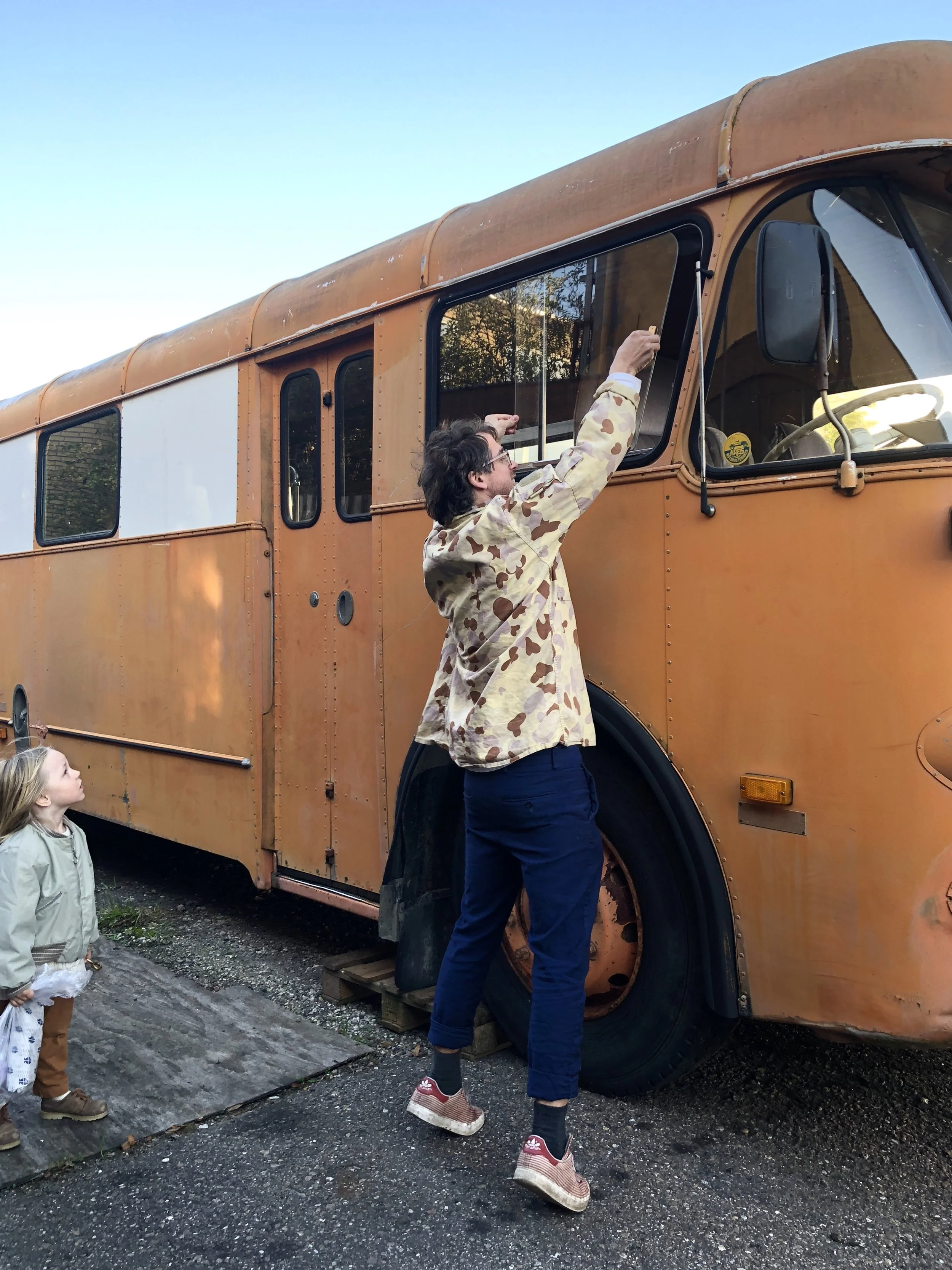 Emil and Leopold fixing the windows in the bus.