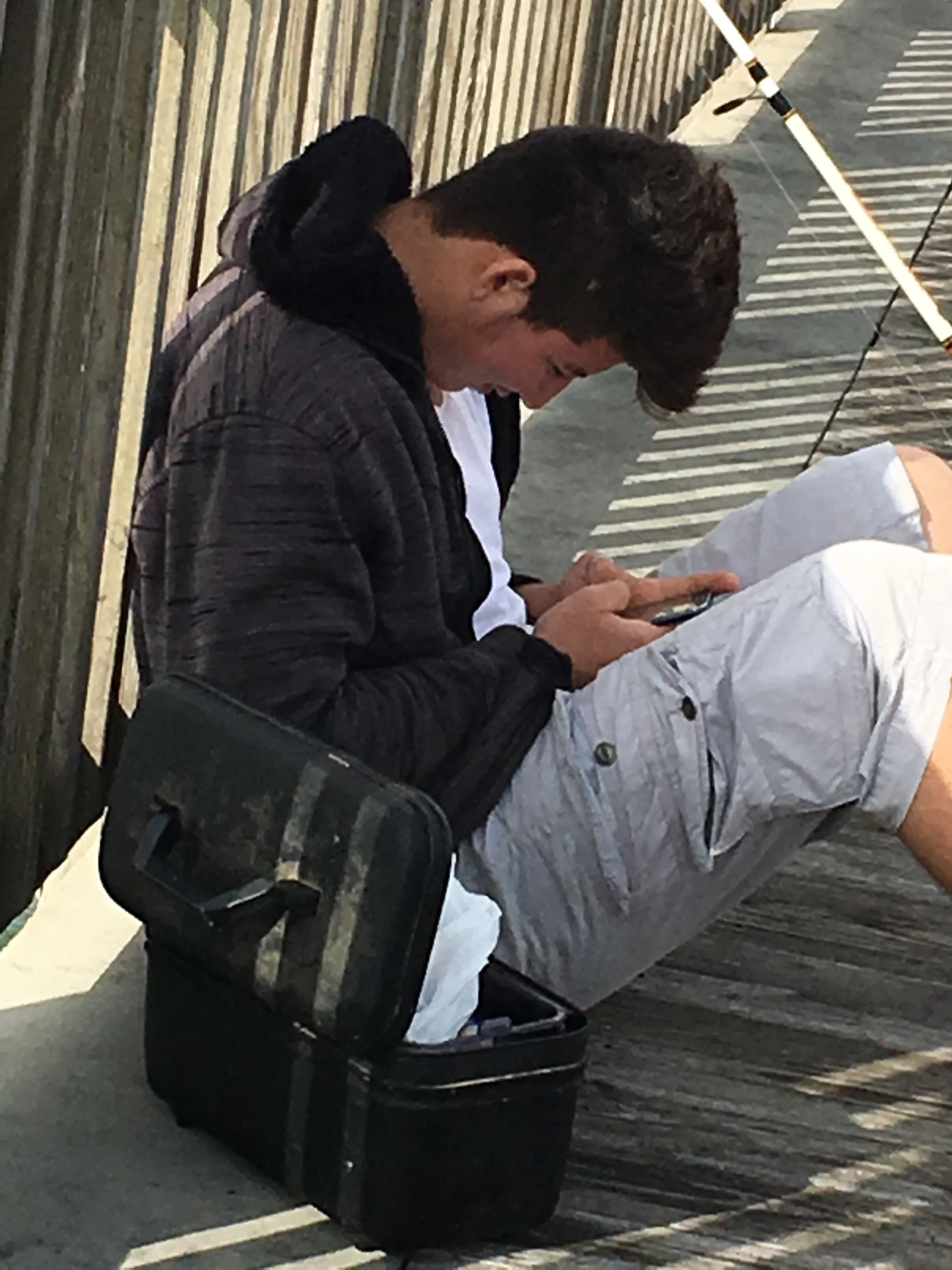 Modern day fisherman on his phone