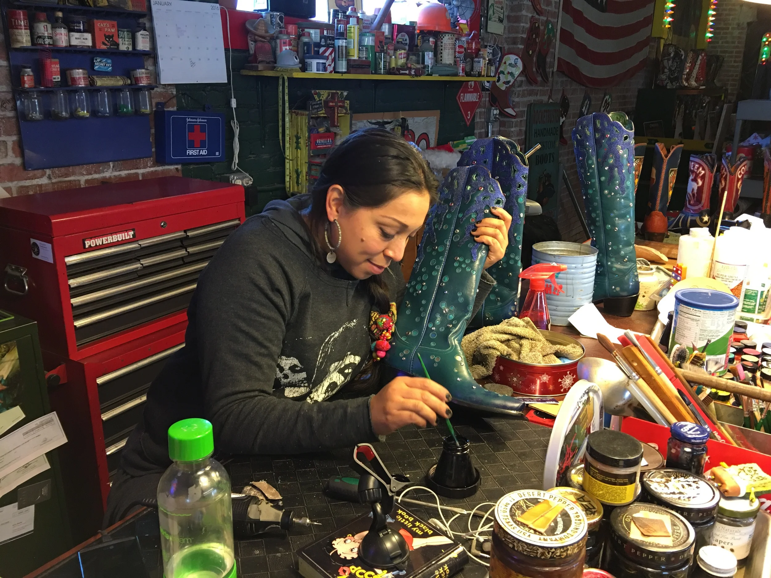 One of her artists working on "under the sea" boots. Notice the bubbles