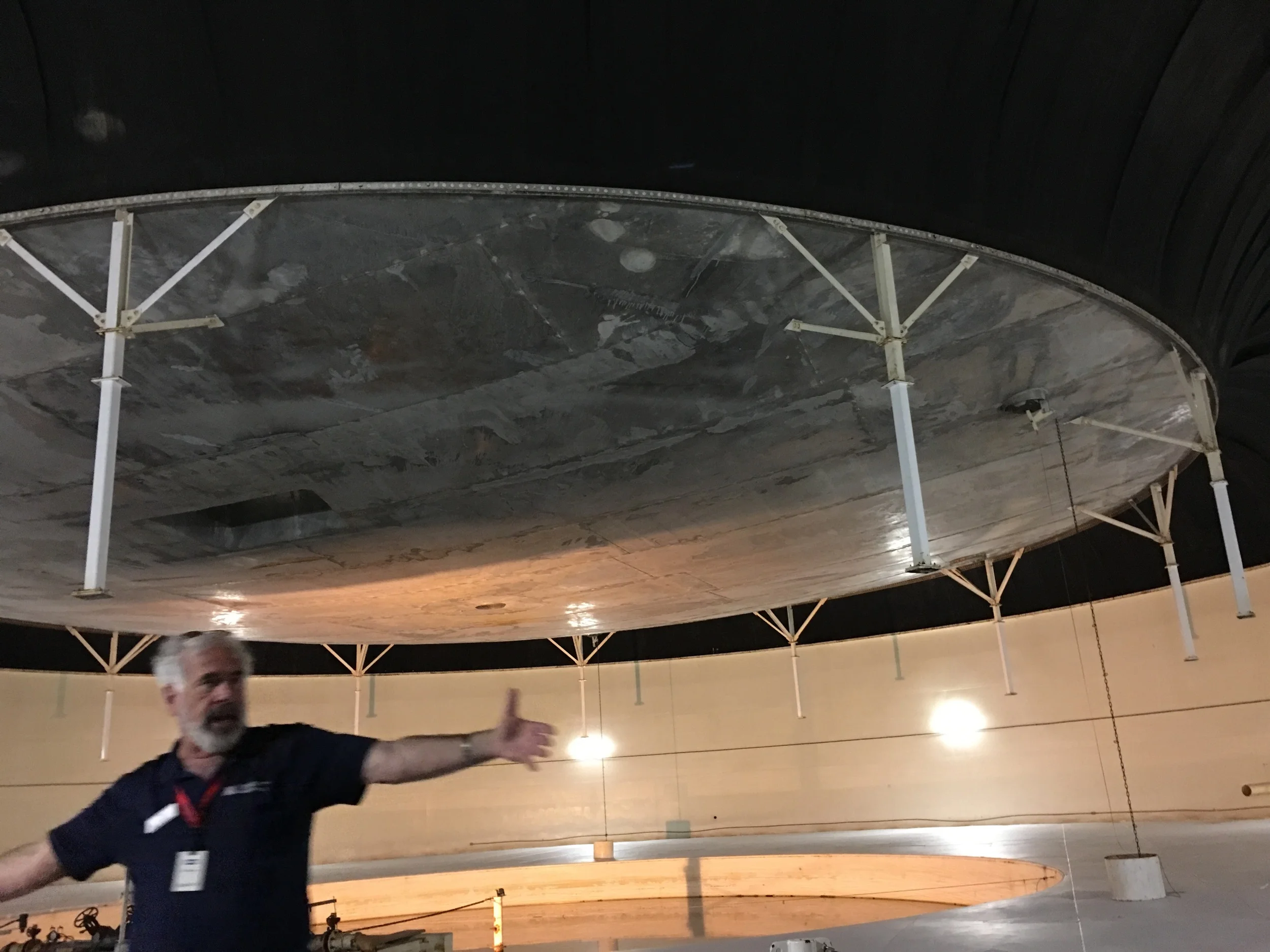 The elevated "bladder" is not attached to anything. It raises and lowers according to the changes in air pressure inside the structure. The basement is called the "technosphere". The weather is produced by technology.