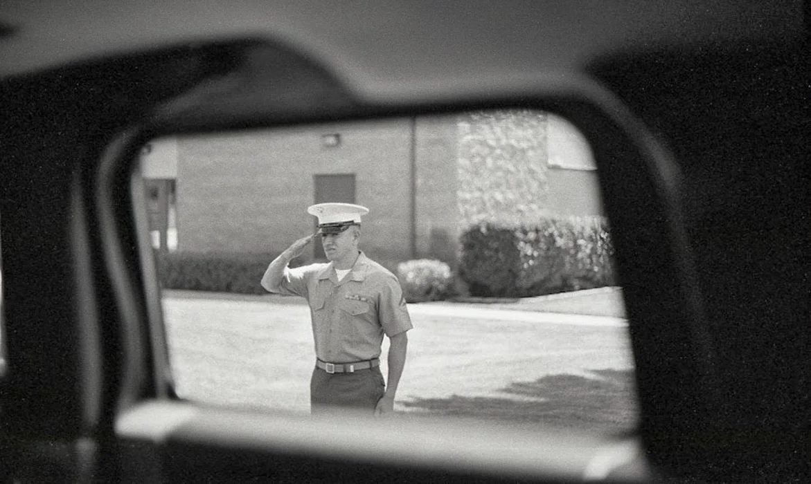 A Marine renders a salute as the funeral precession for SGT Eric Williams leaves Camp Pendleton.