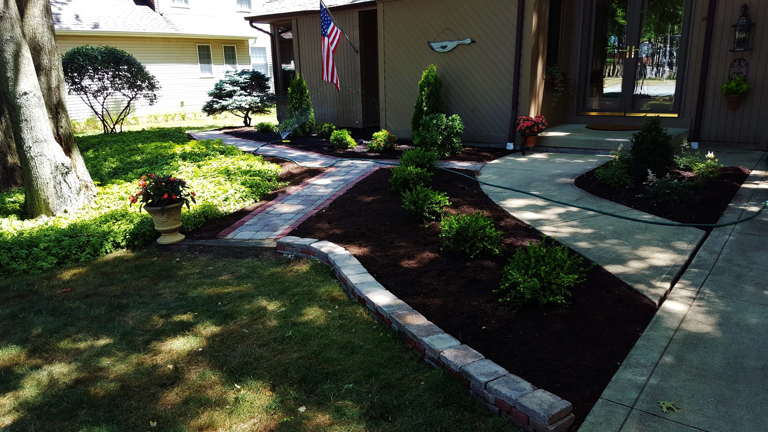 Landscape design and implementation. Included paved walkway and retaining wall.