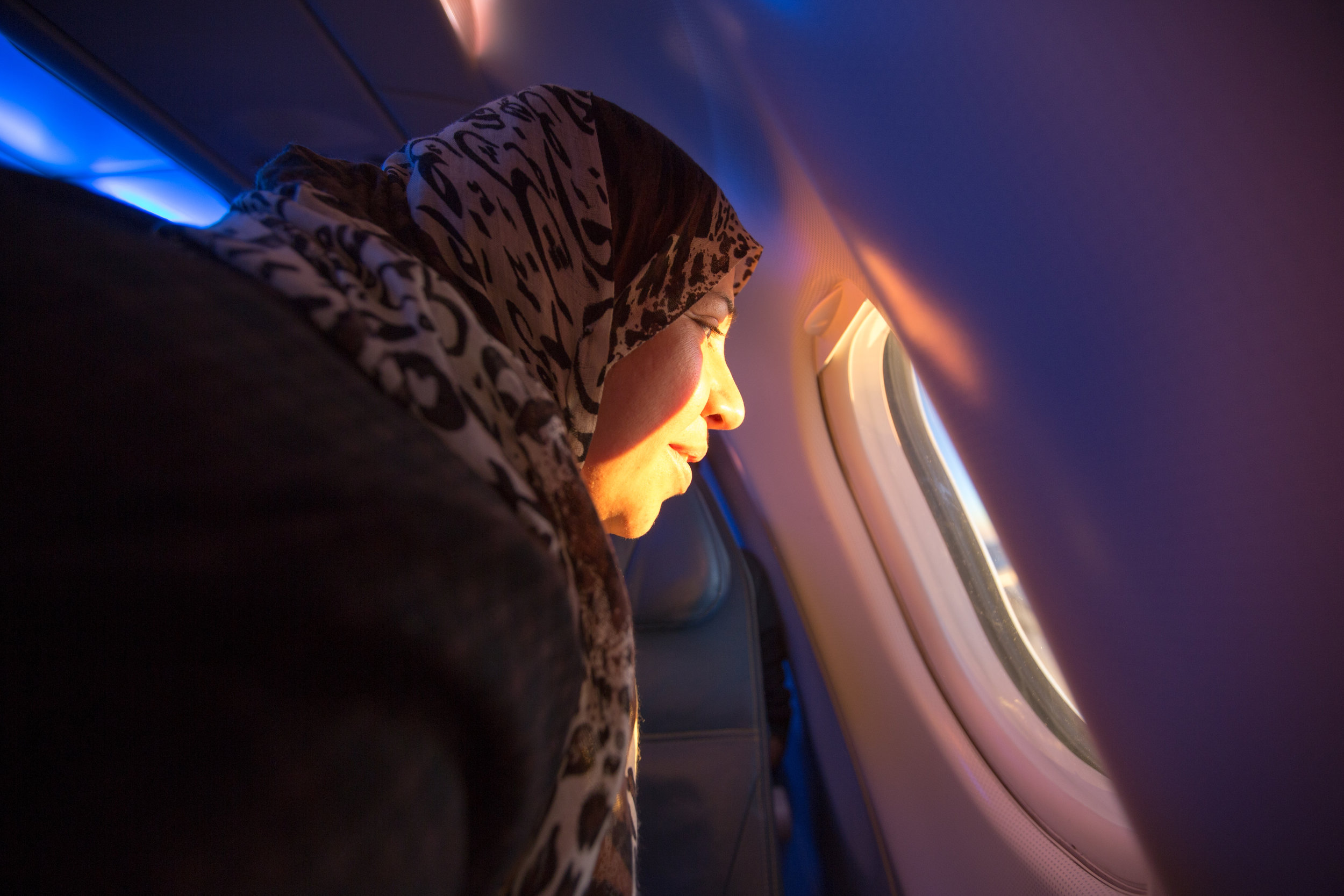  A Syrian woman looks out towards the Swiss Alps for the first time while on her flight to Toronto. She is among many Syrians who were resettled into Canada in 2015. 