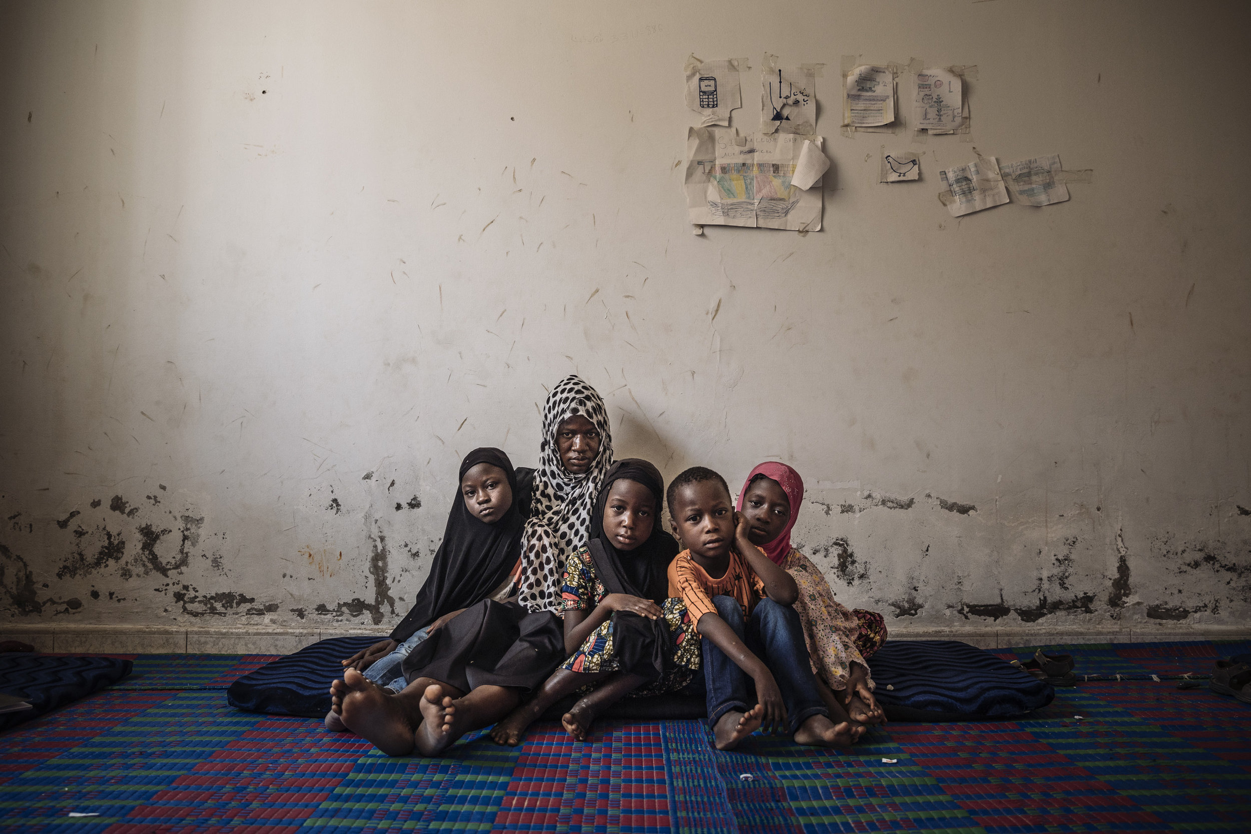 Diaraye Conde sits in a migrant reception center with her four children in Nouakchott, Mauritania. Originally from Guinea, she came to Mauritania five months ago with her husband who later fell ill and died. Devastated, Diaraye and her family are now stranded in Mauritania with no idea where to go as her husband hand made all of the arrangements.