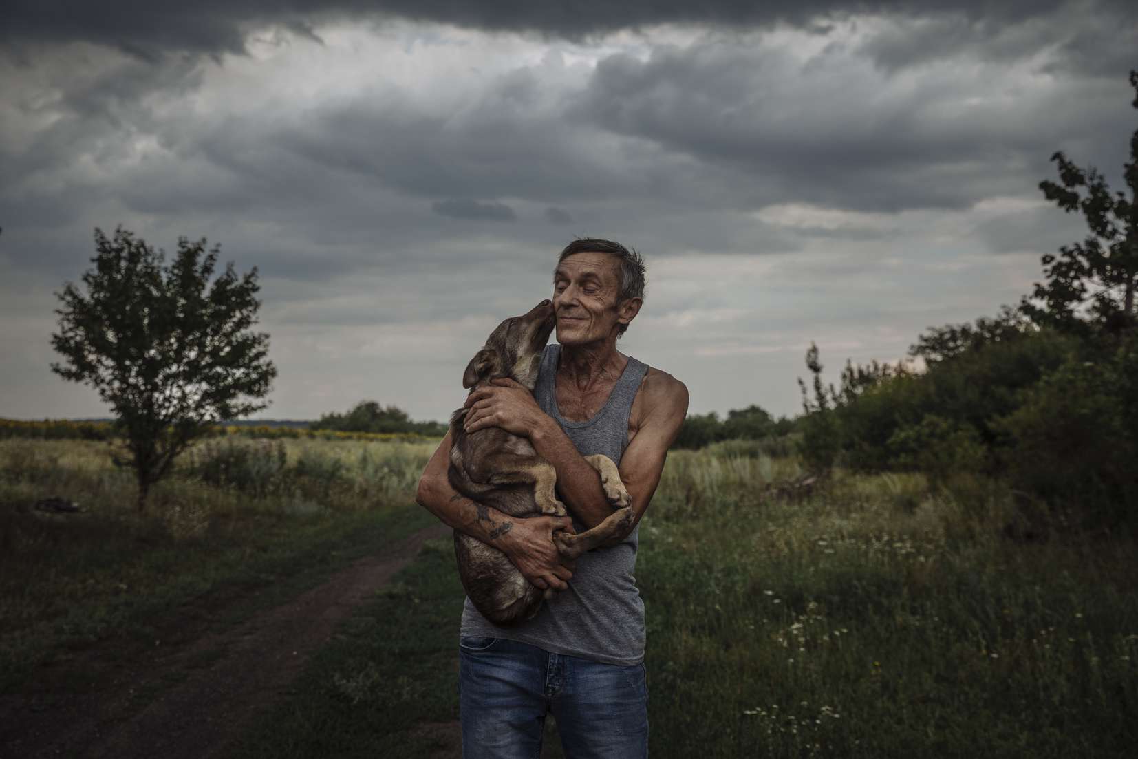 Valerii holds his dog Dik, who was a stray dog that was anonymously dumped at their home in Eastern Ukraine. When he, who has become internally displaced from the ongoing conflict in Ukraine, saw the dog he decided to keep it and take care of it saying, “We can’t leave him alone because someone just dumped him. We were also just dumped aside because if this war so we know exactly what he’s going through.”