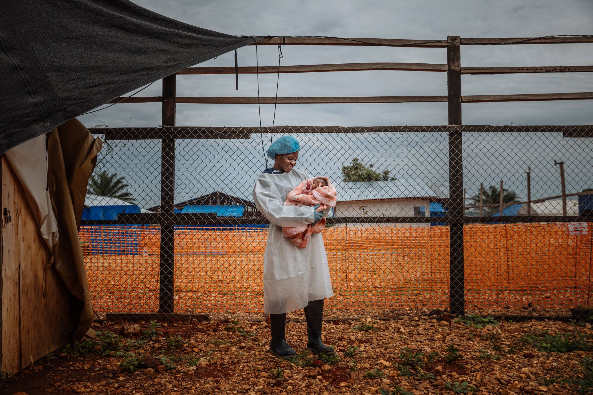 Mulasi Musaba, an Ebola survivor, cares for the daughter of an Ebola patient at a treatment centre in Ituri Province. Survivors' personal experiences give patients hope. 'When I arrived here, I did not think I would ever get healed. But eventually I