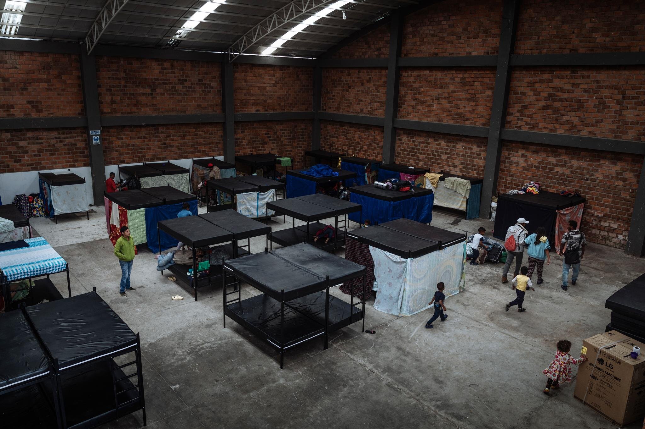 Children get settled in the women and children’s section of a shelter in Ipiales, Colombia, located on the border with Ecuador. Venezuelans can receive a bed, a warm meal, health services and psychosocial counselling before continuing their journey.