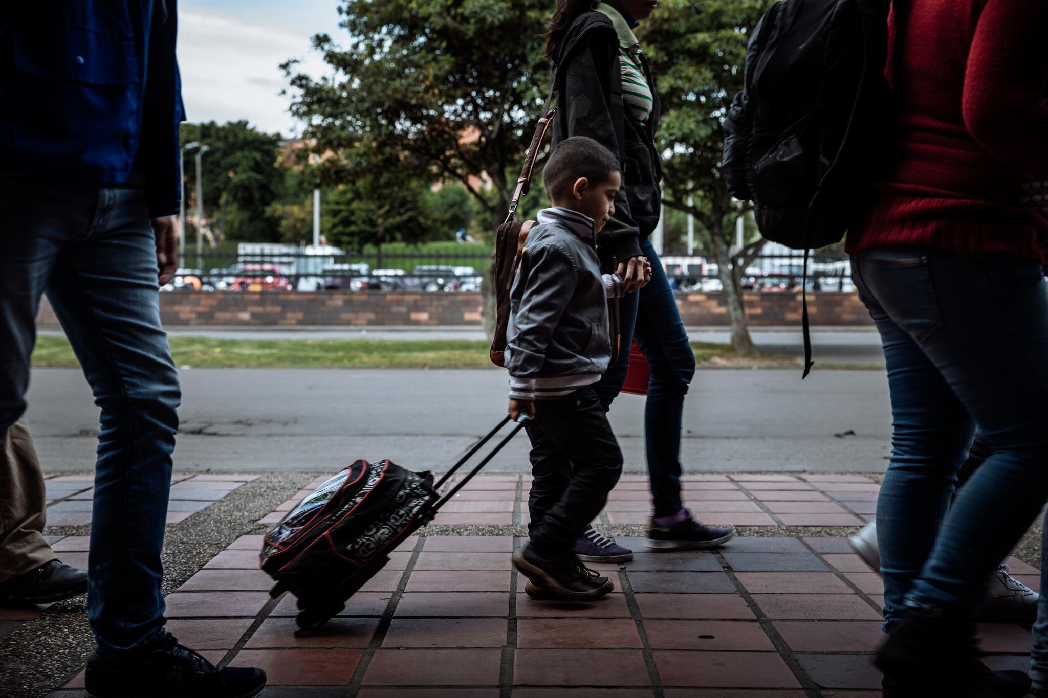 A Venezuelan family leaves the bus terminal in Bogota, a hub for Venezuelans transiting through the Colombian capital. Bogota’s Mayoral Office runs an information point in the station where migrants and refugees can connect to services provided by h