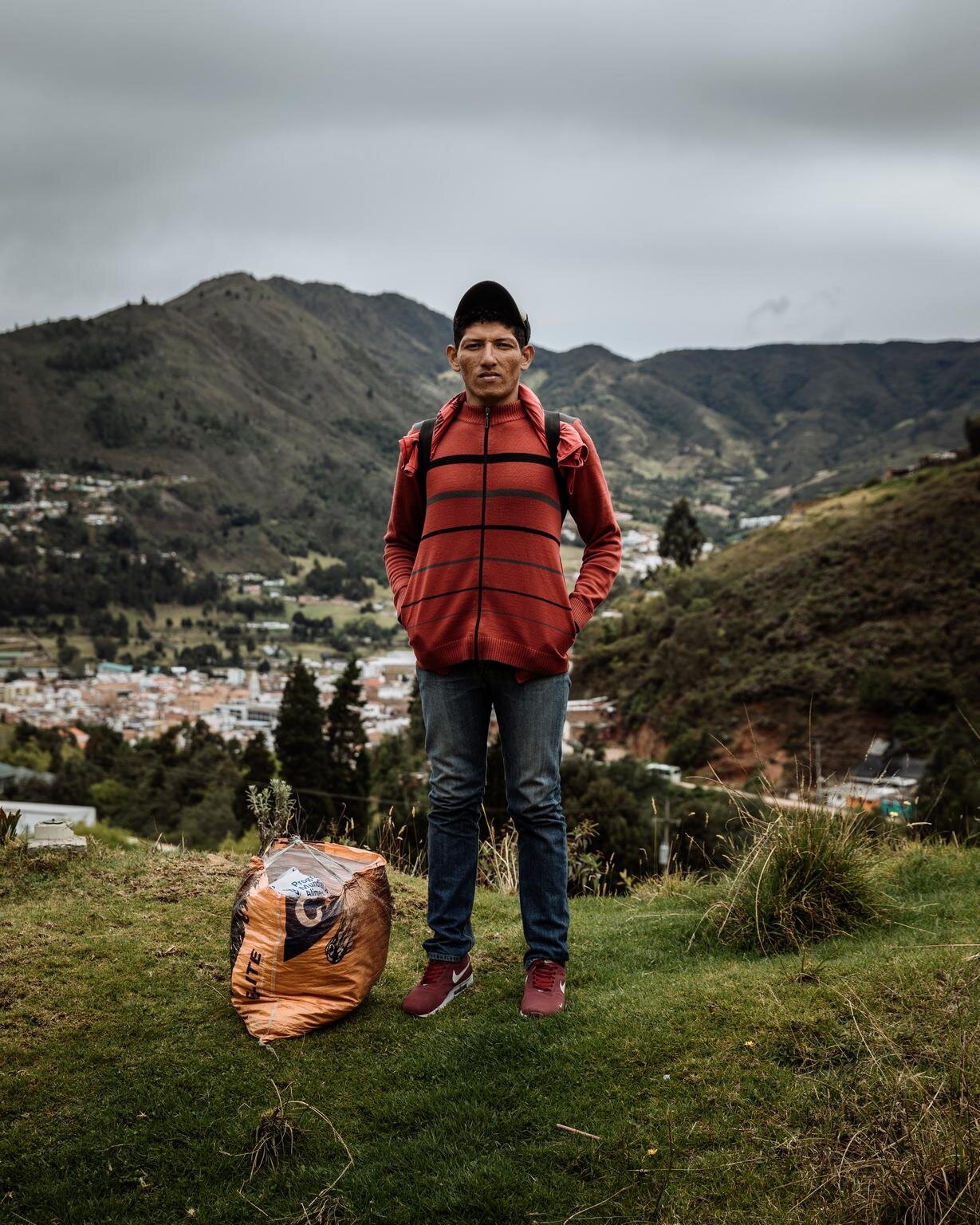 Rigoberto pauses on the side of the road on the outskirts of Pamplona, Colombia. He has been walking for three days toward San Gil where he hopes to find work on a coffee plantation. “I used to work for an electrical company,” he says. “I was paid