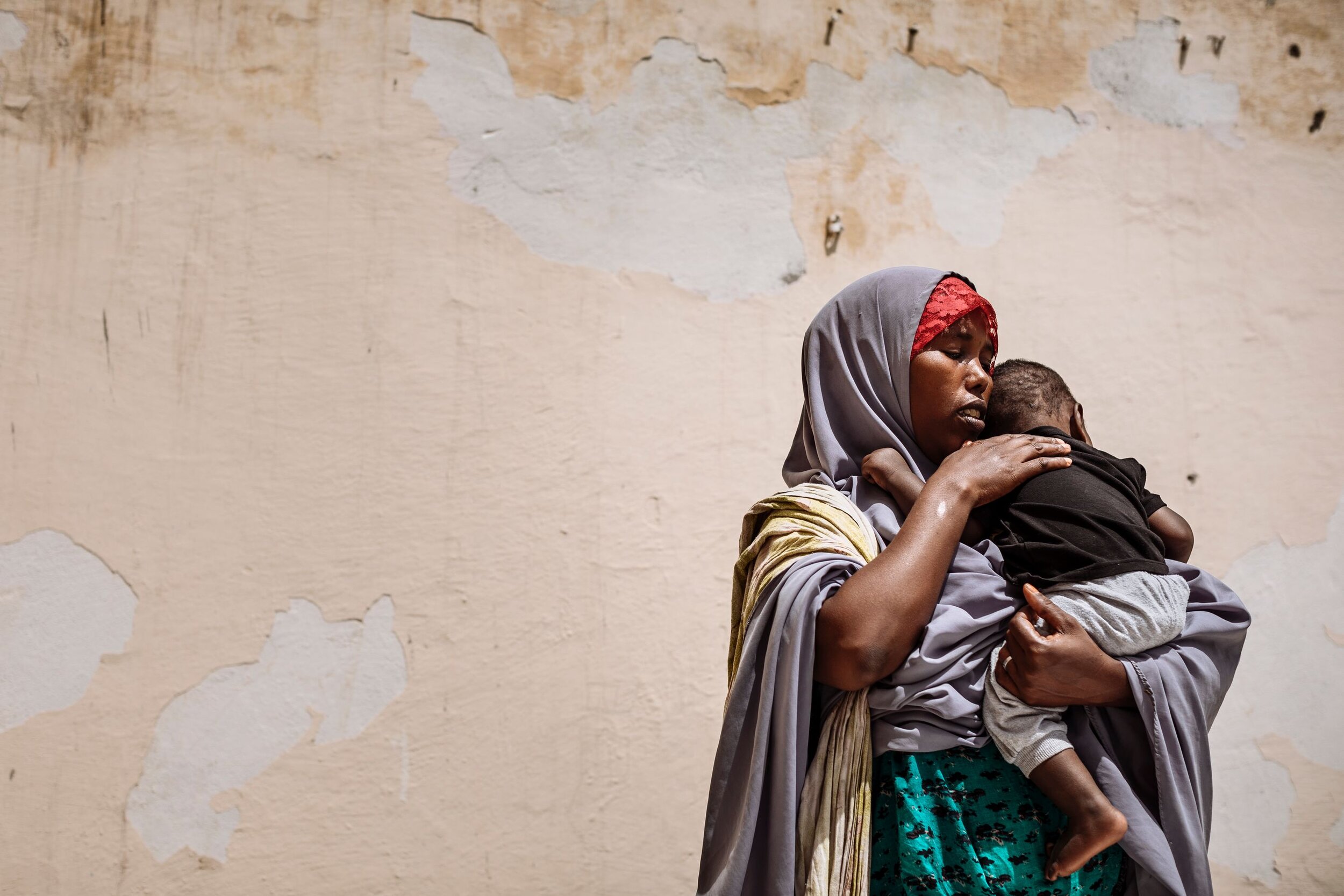 Farhiya and her eight-month-old son await to return to Ethiopia at a reception centre in Bosasso, Puntland. She arrived in the country five months ago to look for her husband who left without a word. She heard rumours that he wanted to cross the Gul