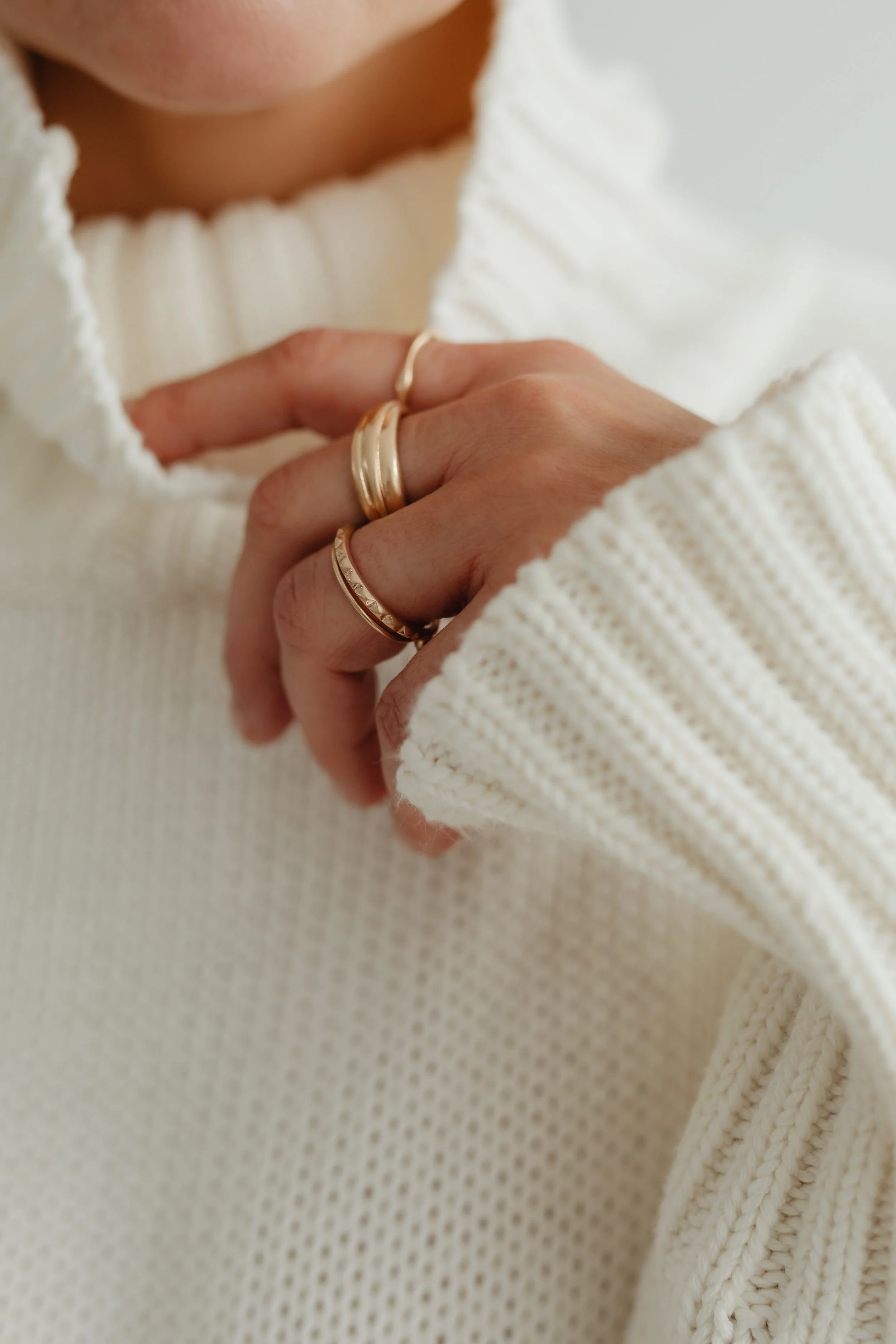 kaboompics_woman-in-white-sweater-gold-rings-jewelry-29420.jpg