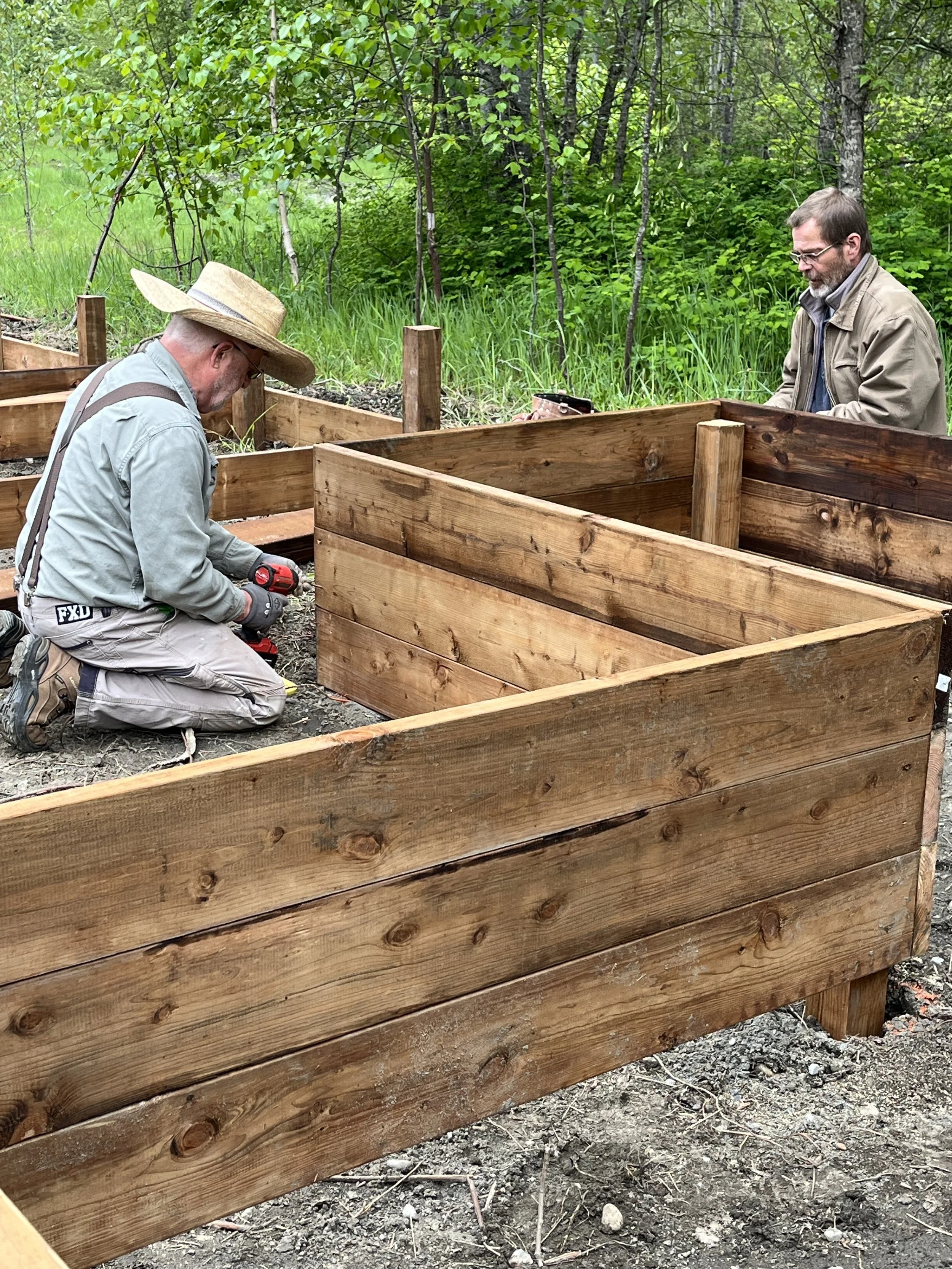 Volunteers constructing community garden beds