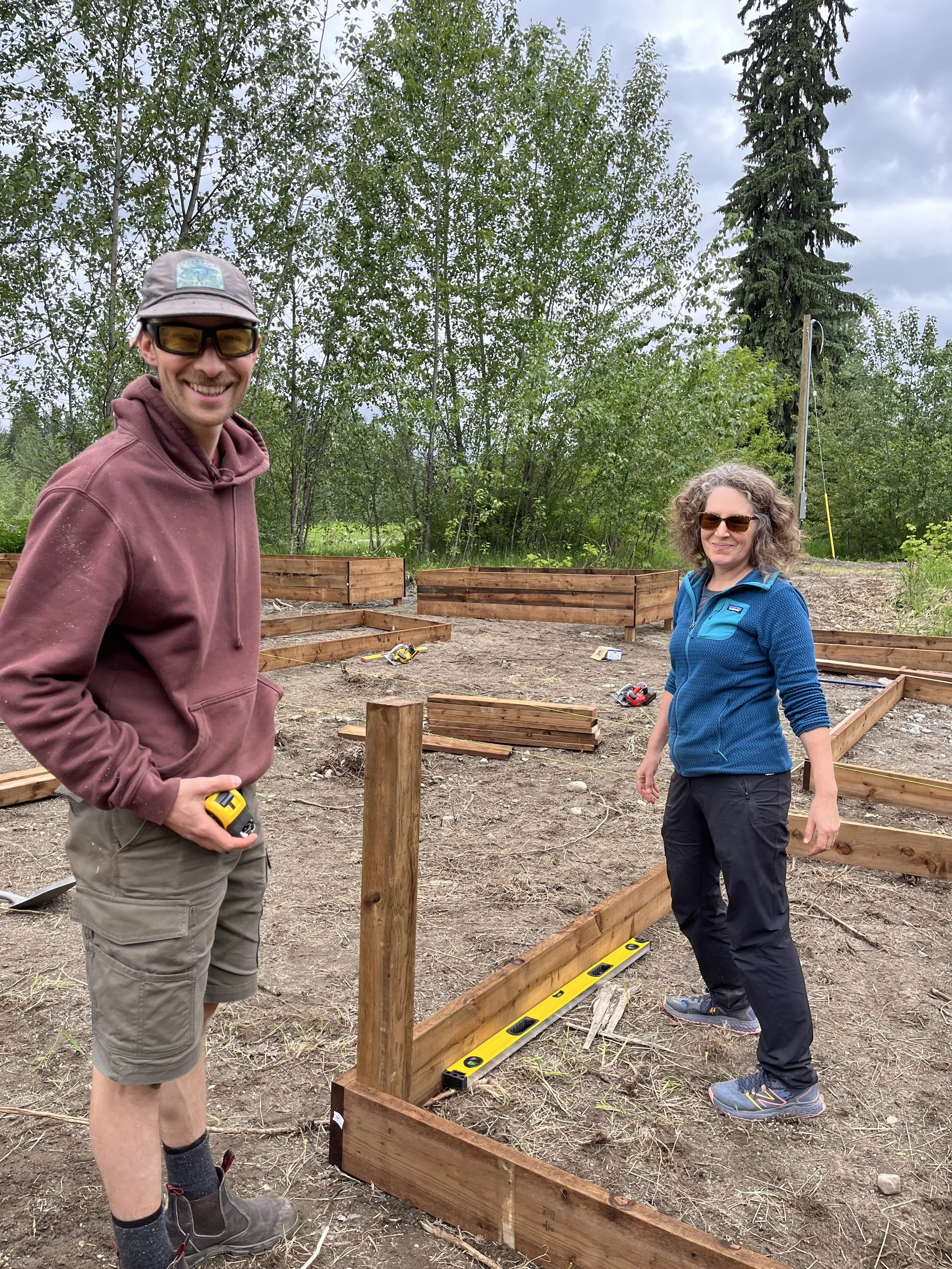 Volunteers constructing community garden beds
