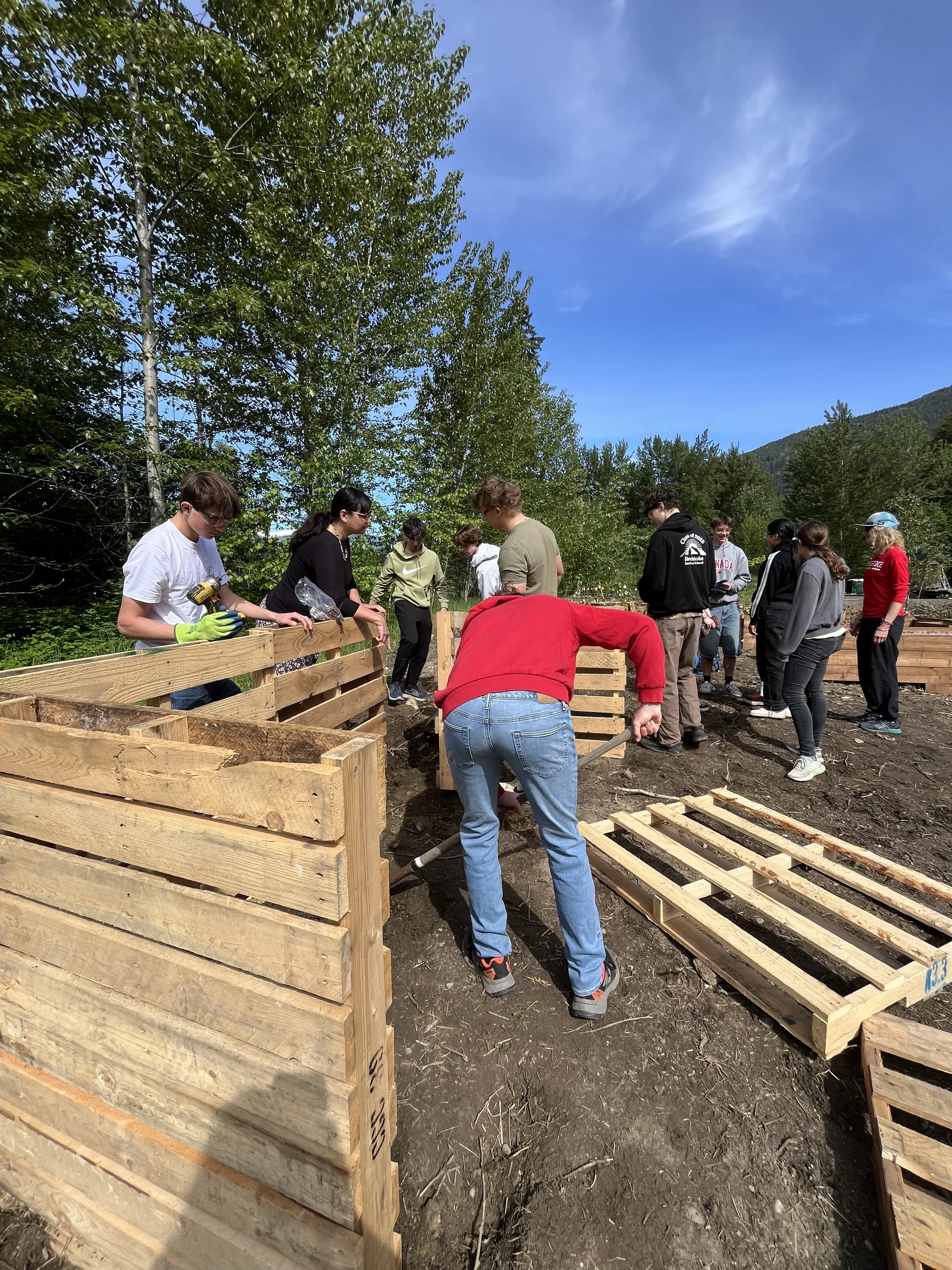 Grade 11/12 Biology class building a composter at the Food Commons