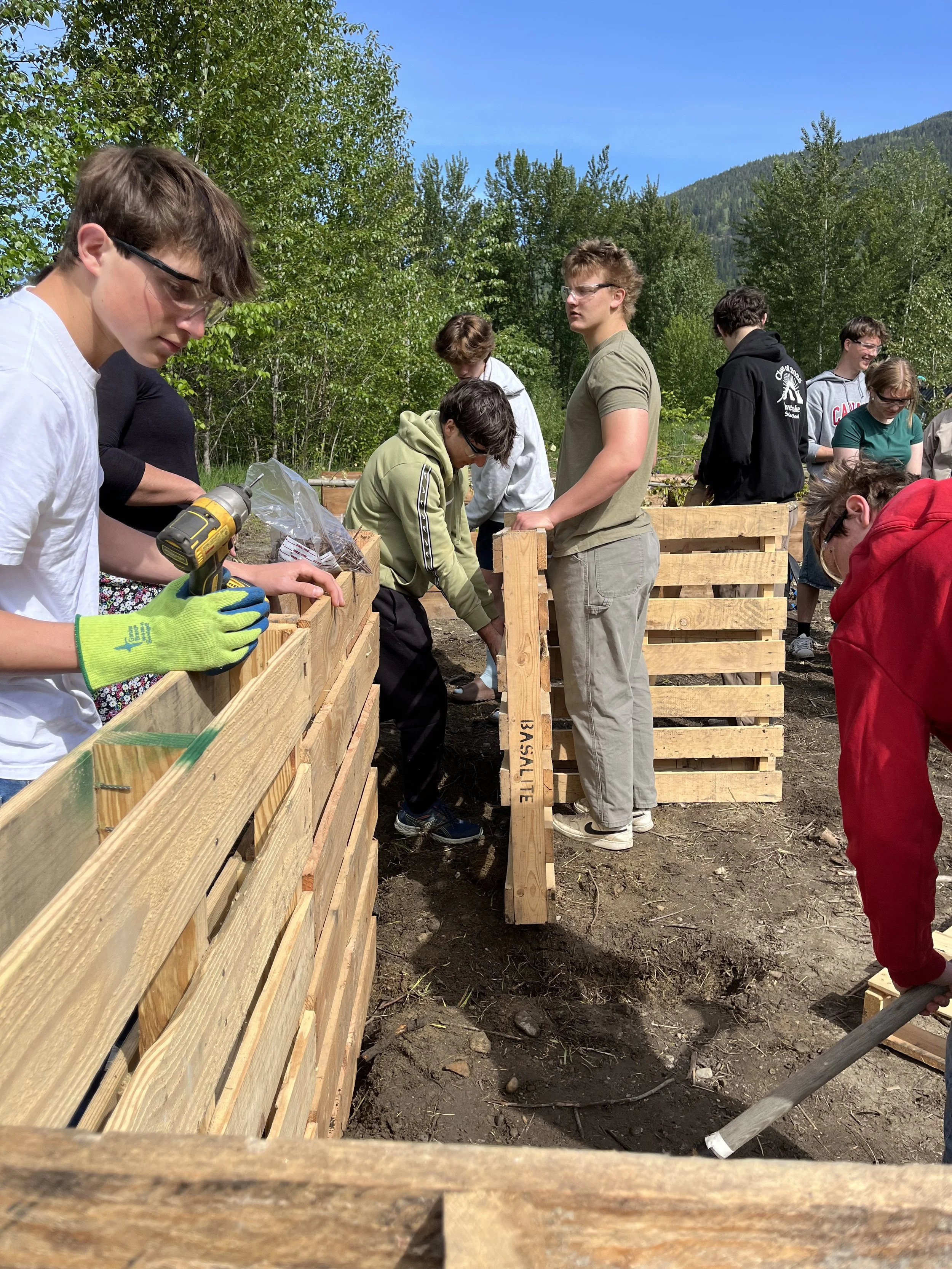 Grade 11/12 Biology class building a composter at the Food Commons