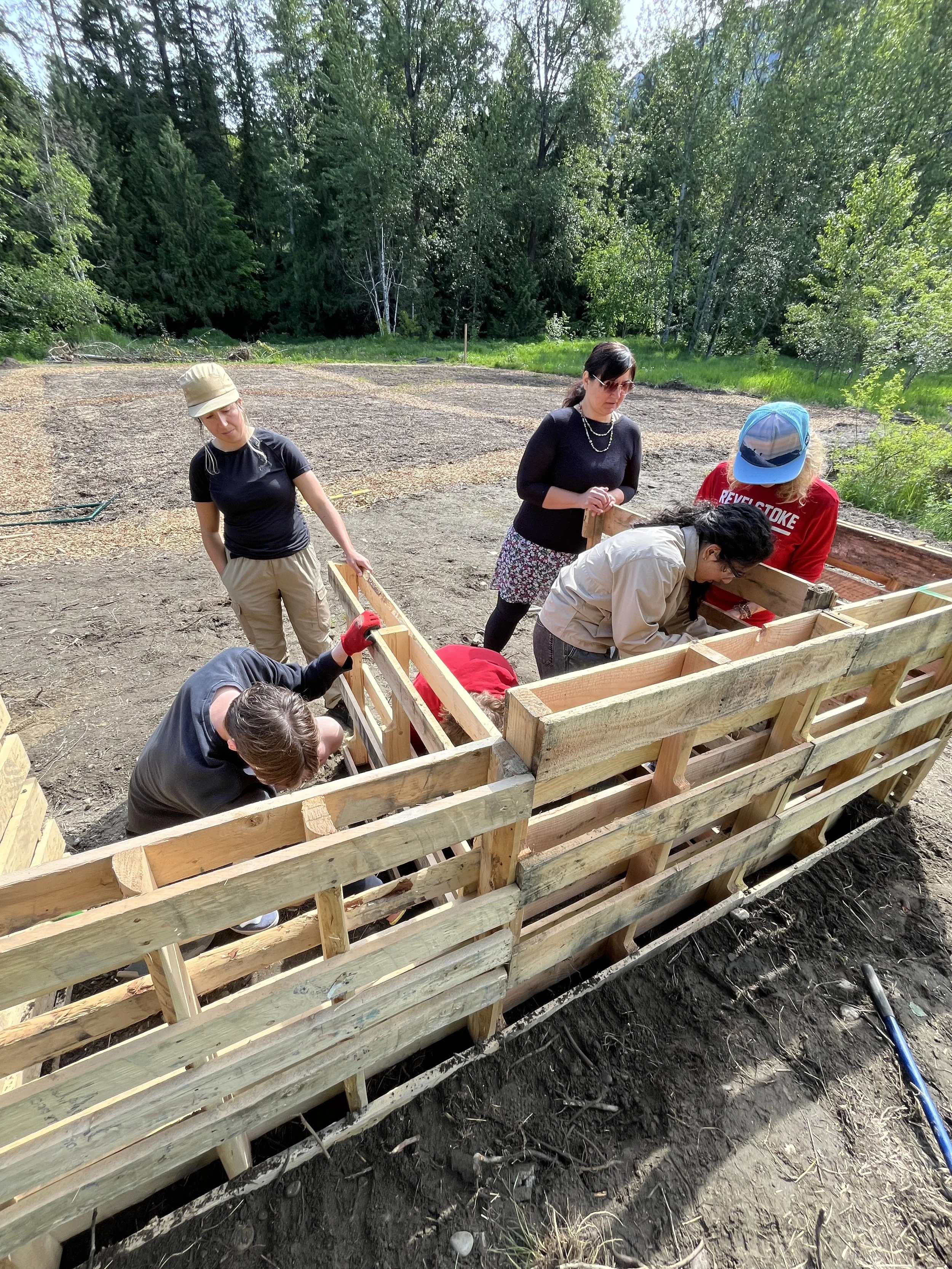 Grade 11/12 Biology class building a composter at the Food Commons
