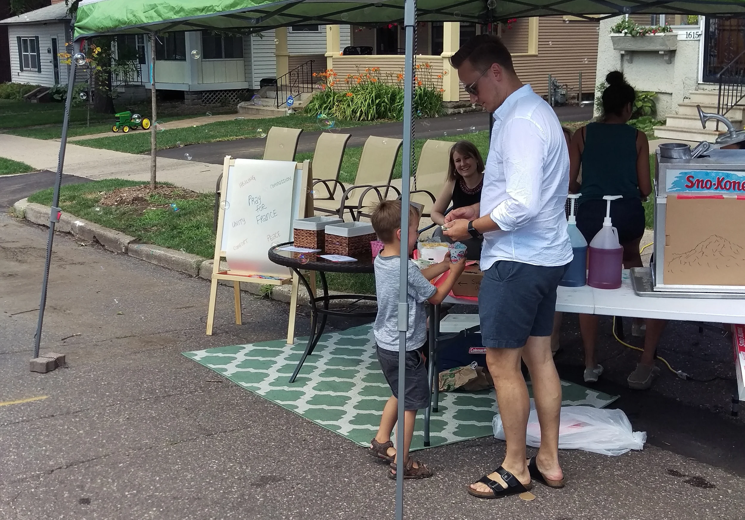 A family gets some snow cones. 
