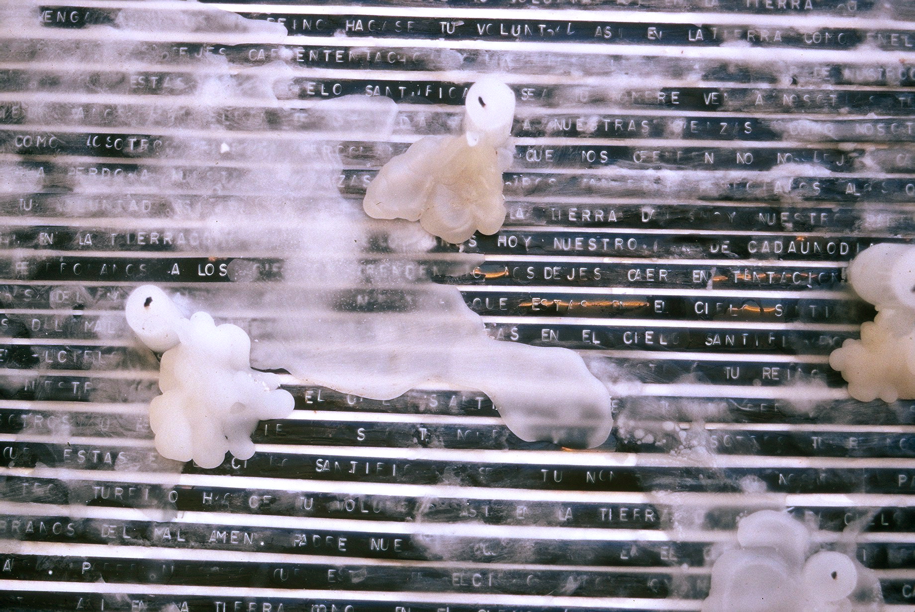 "Our father" This piece is a process art piece, where the artist prayed "our father" with a label maker, until the total canvas was covered. She then lit up 13 candles for 13 minutes and 13 seconds and blew them away. The number 13 representing the titles of the Colombian constitution and that of the protection of everyone in Colombian territory. The artist believes that much was left to religion and prayer when more legal action should have been taken by not only the government but also the whole world. 