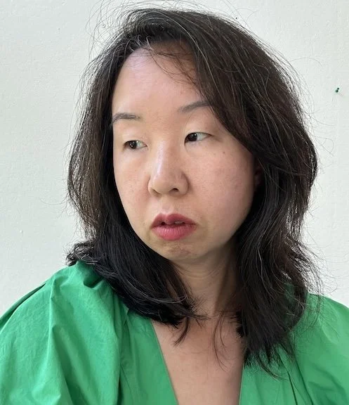 headshot of Shelley Wong in a green dress