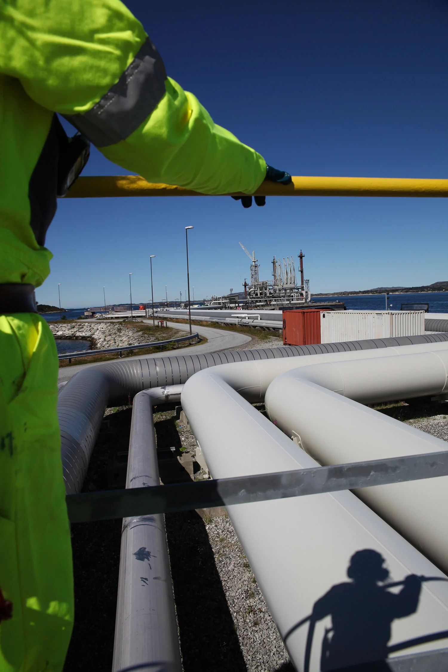 Pipelines lay along the dockside at Mongstad oil refinery outside of Bergen, Norway, on Thursday, Aug. 11, 2011. Photographer: Heidi Wideroe/Bloomberg