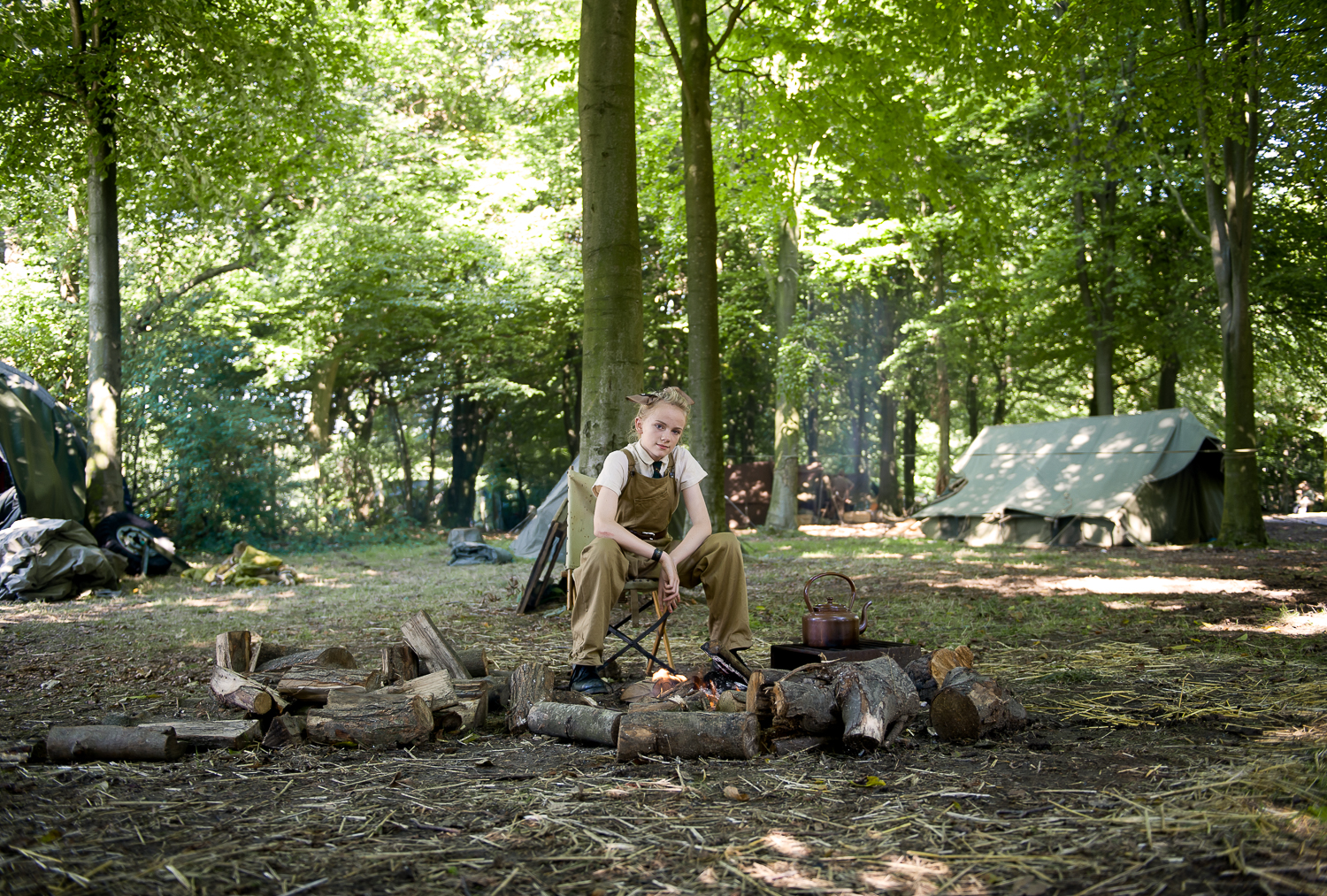  Young female re-enactor preparing tea, multi period re-enactment event in Essex 