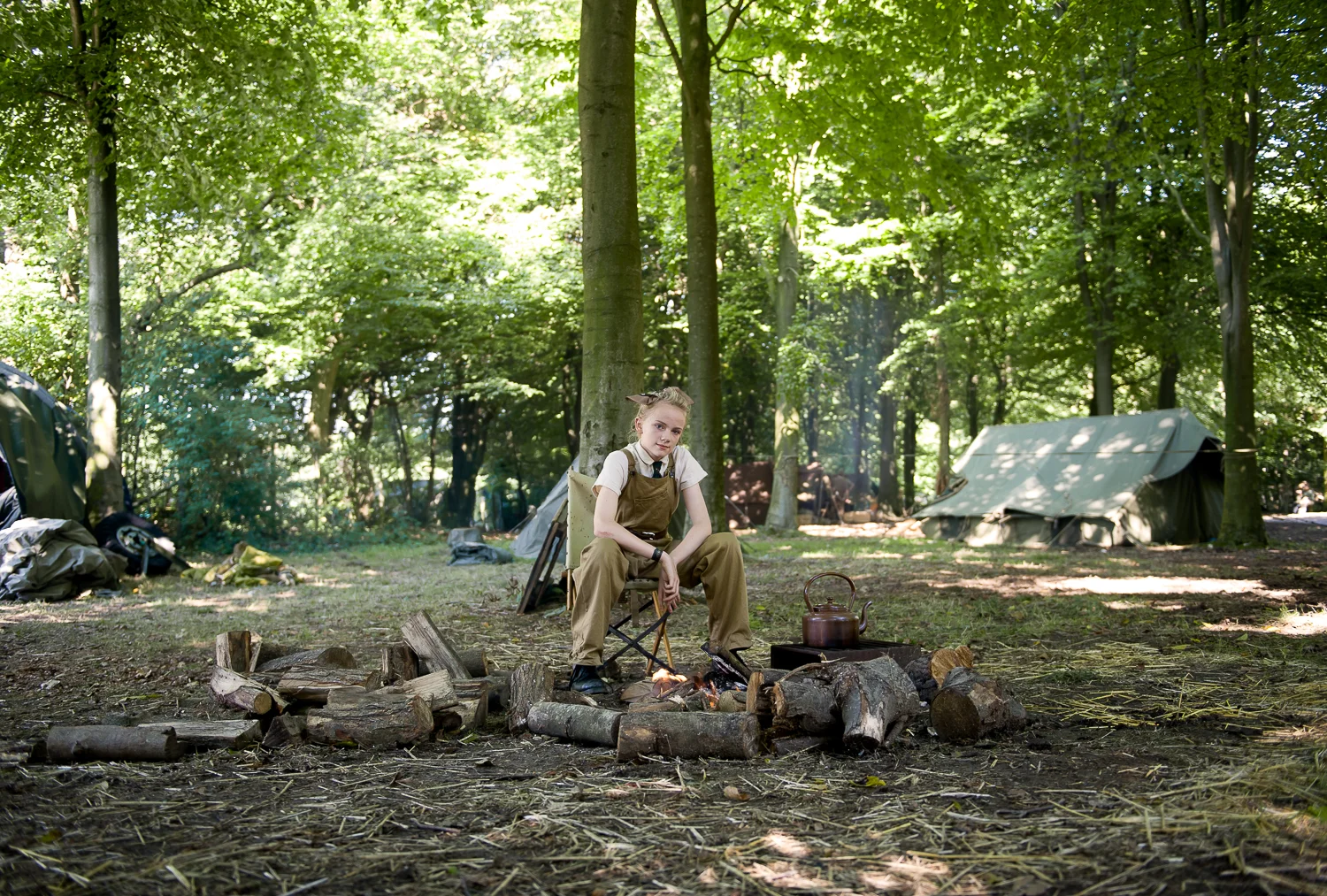 Young female re-enactor preparing tea, multi period re-enactment event in Essex