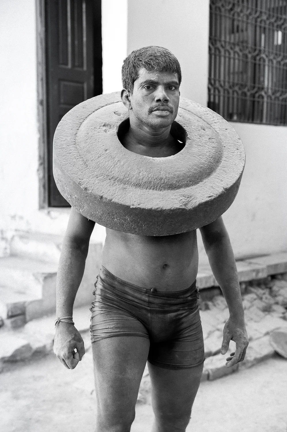 Kushti Wrestler exercising with concrete slab, Varanasi, 2019