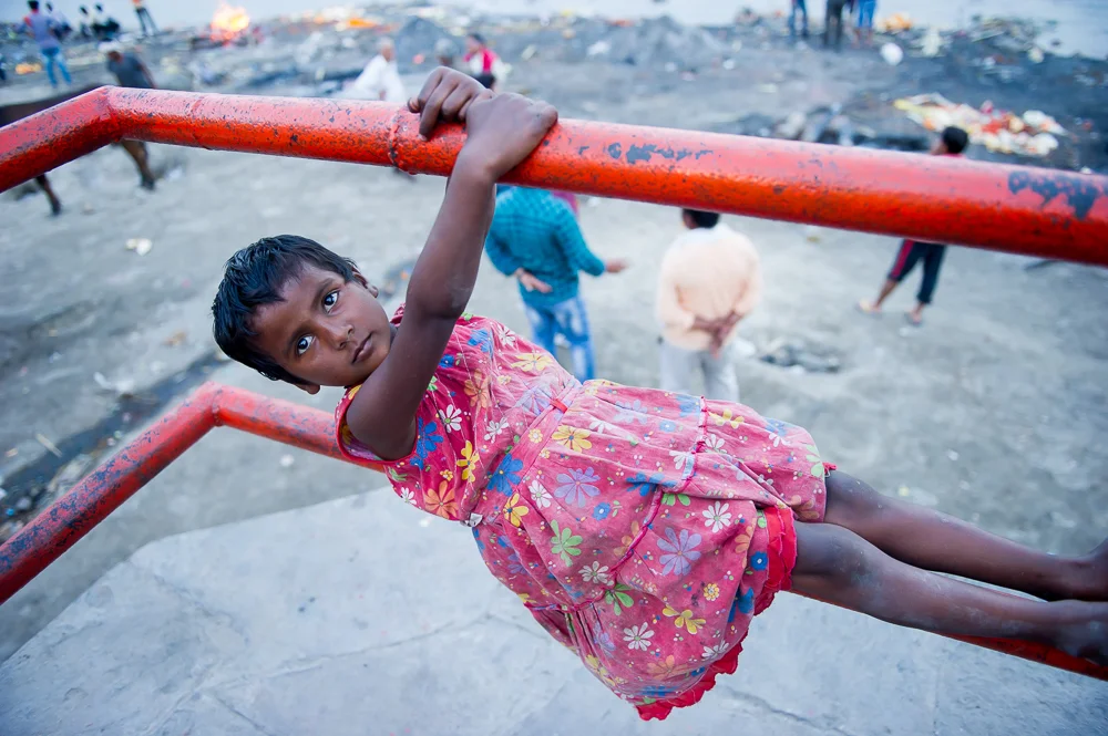 Young girl near burning ghat, Varanasi, 2019