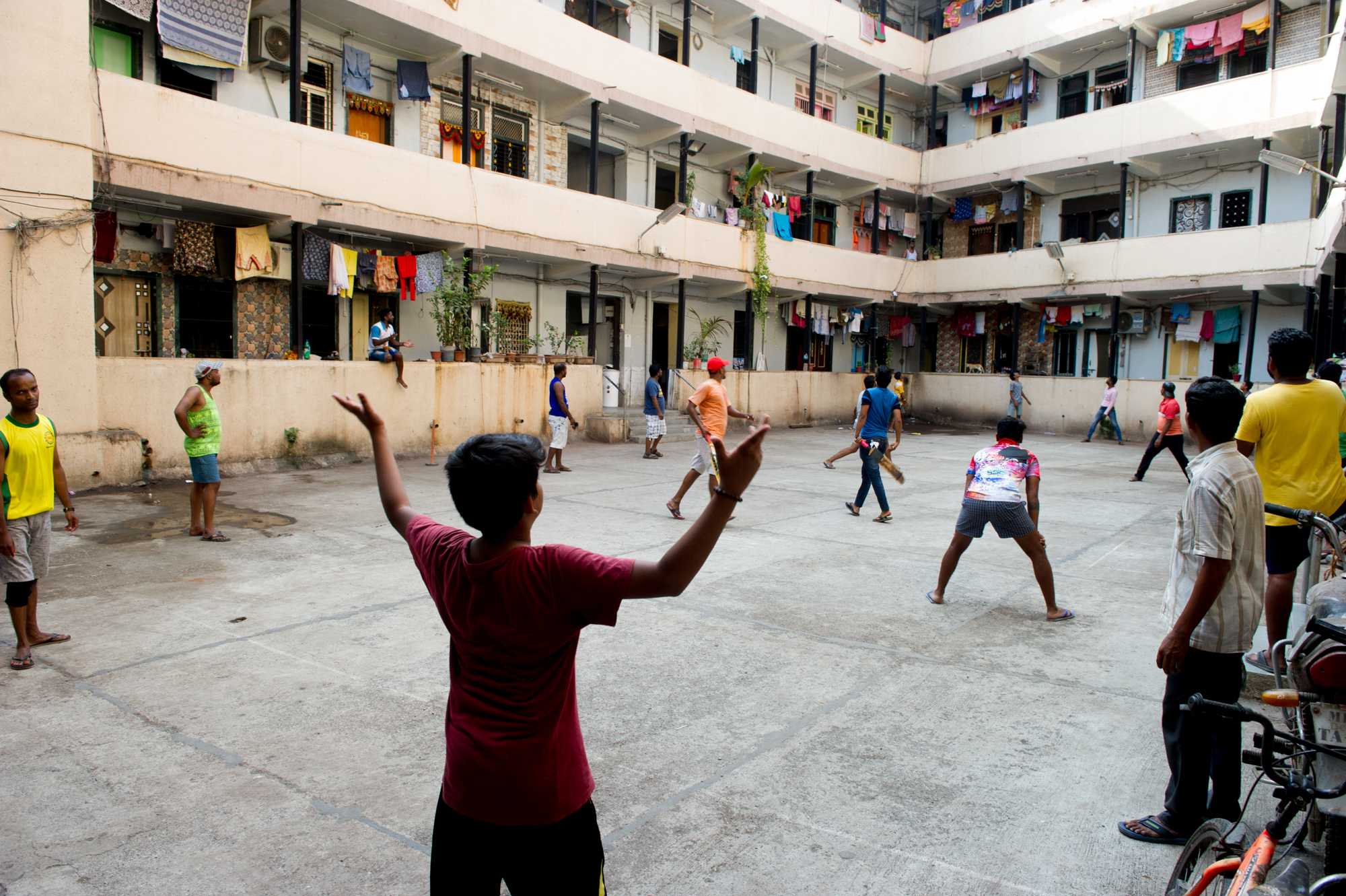  Residents playing cricket in the residential complex in Mumbai, 2019 