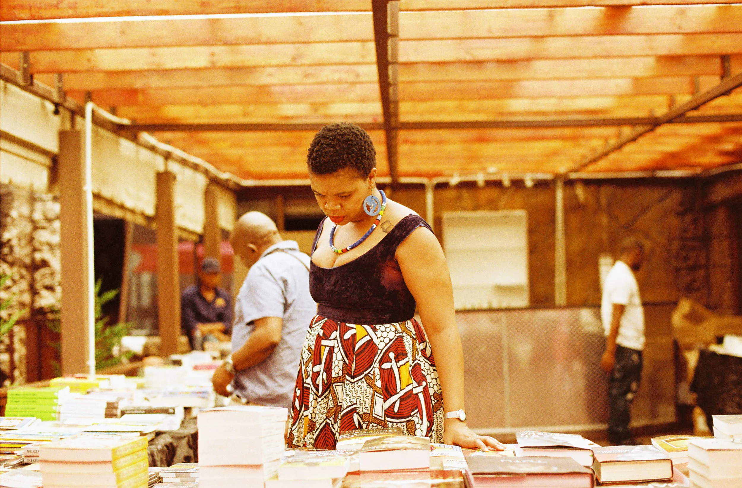 Captured at Abantu Book Festival browsing book titles, Malebo Sephodi. Photo credit: Lidudumalingani
