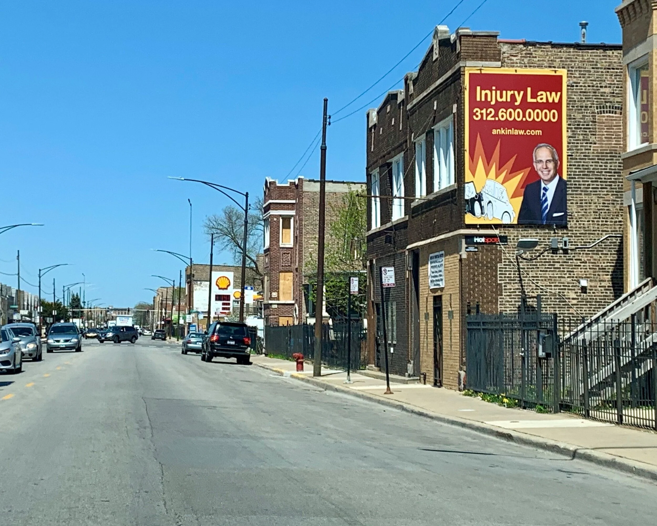 Injury law billboard advertising displayed along a busy city street to build local law firm recognition